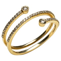 Fascia tripla in oro 18K con diamanti incastonati