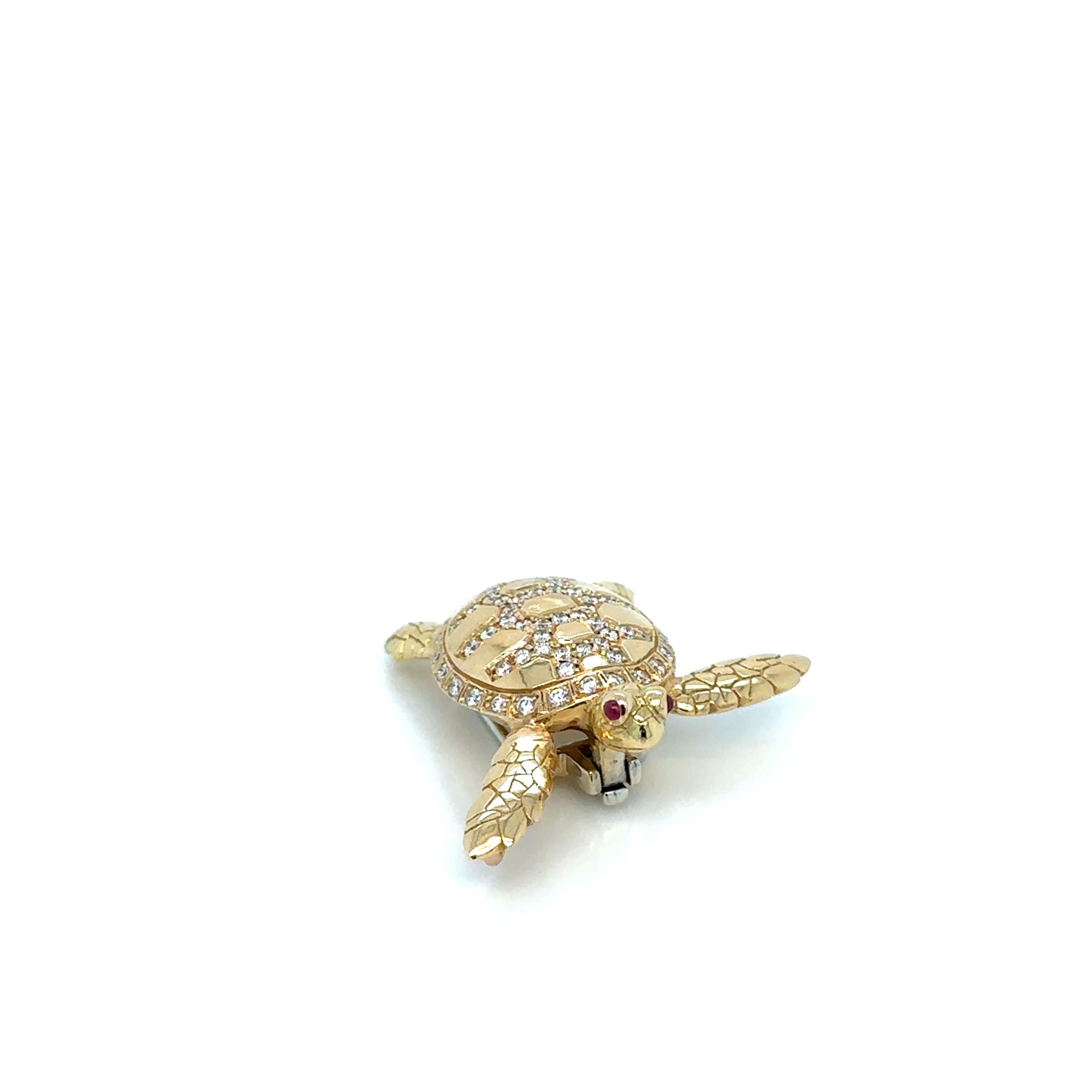 Presenting an exquisite 18K gold pendant and brooch, masterfully crafted in the shape of a turtle. This unique piece captivates with its cabochon-cut ruby eyes, each a deep and rich red, imparting a lifelike, almost mystical quality to the design.