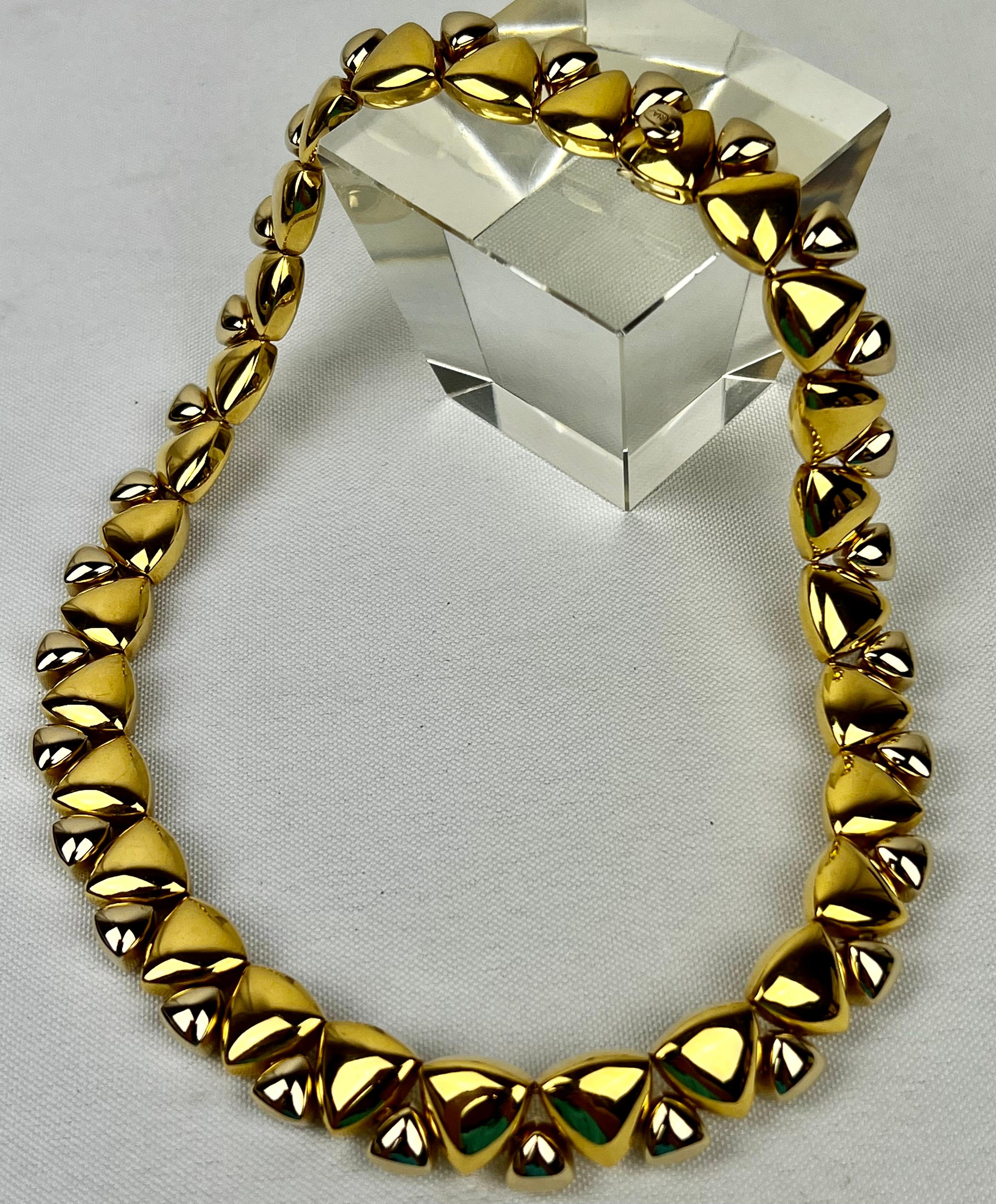 The eighteen karat two tone gold necklace is by Kria.   The necklace consists of 29 identical links with a 5