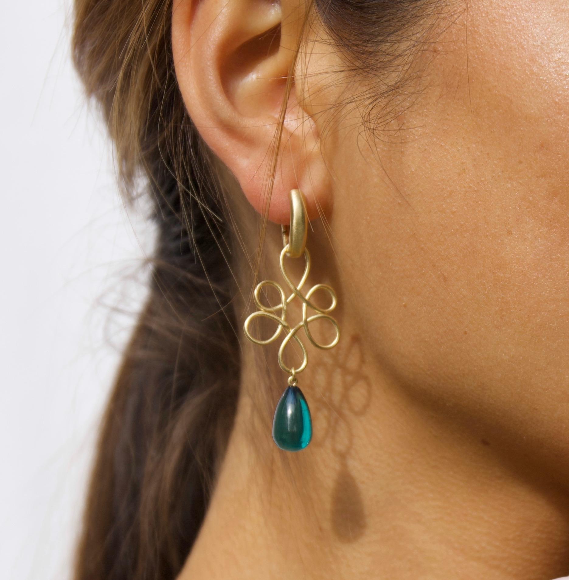 These handmade 18K Gold V-shaped hoop earrings and blue amber drops on 18K gold wire make a great addition to your jewelry collection. The lightweight teal amber drops add just the amount of colour that you need sometimes without taking over. The