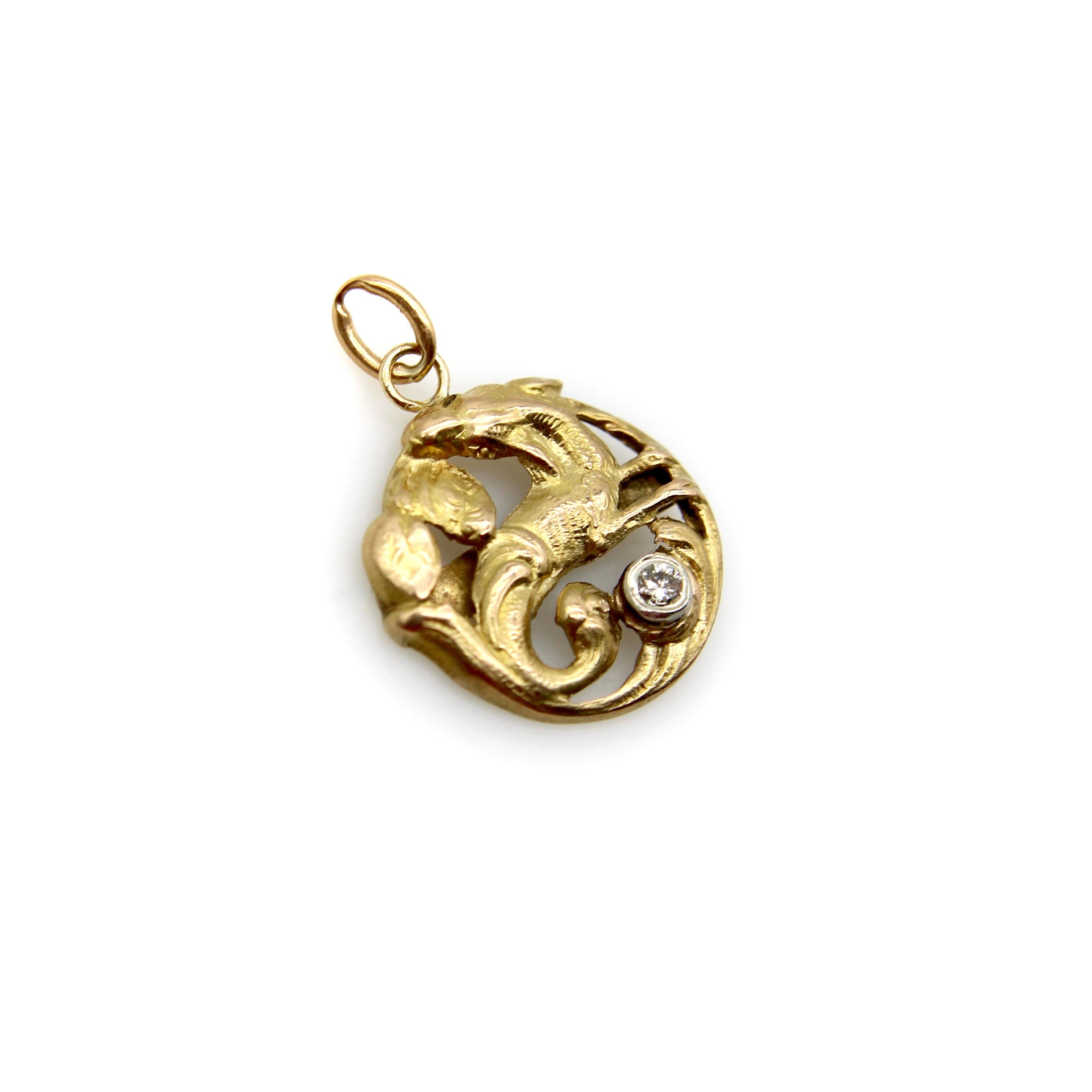 In this 18k gold Victorian pendant, a mythical creature is housed in a round format surrounded by leaves. The creature has the hooves of a deer, the long ears of a rabbit, and the tail of a fish. Below it, an Old European Cut diamond is bezel set in