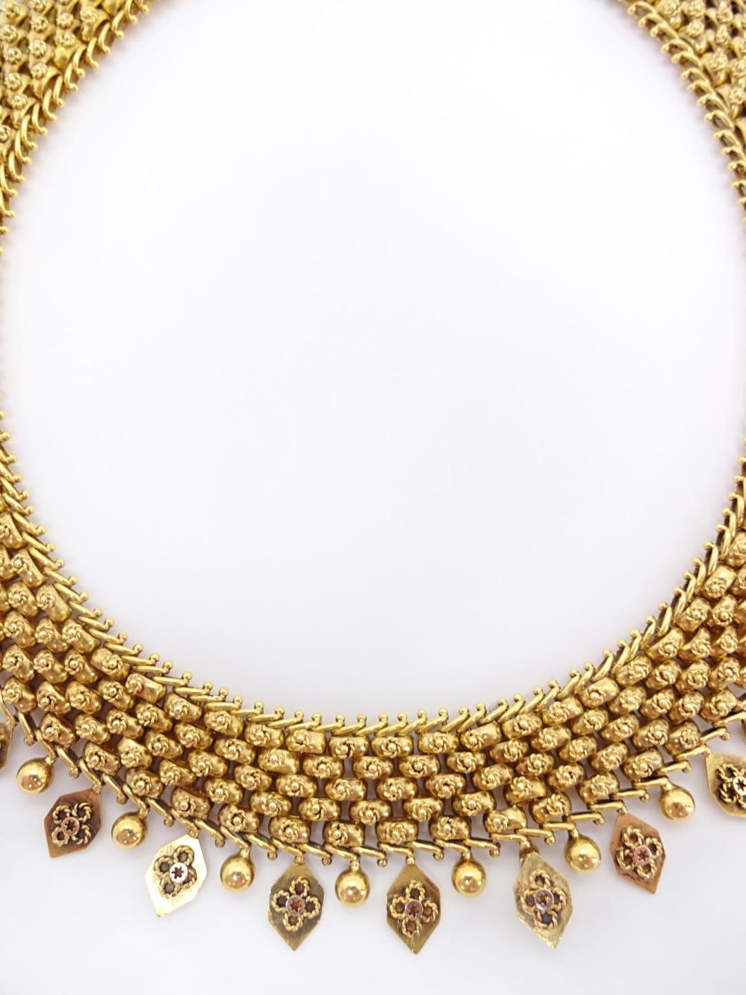 
Each gold ball that connect to form the 5 rows in the body of this collar are decorated with a tiny florette of twisted wire. Entire collar rolls very nicely in your hand or with the body, and is accented by a row of alternating detail pendants;