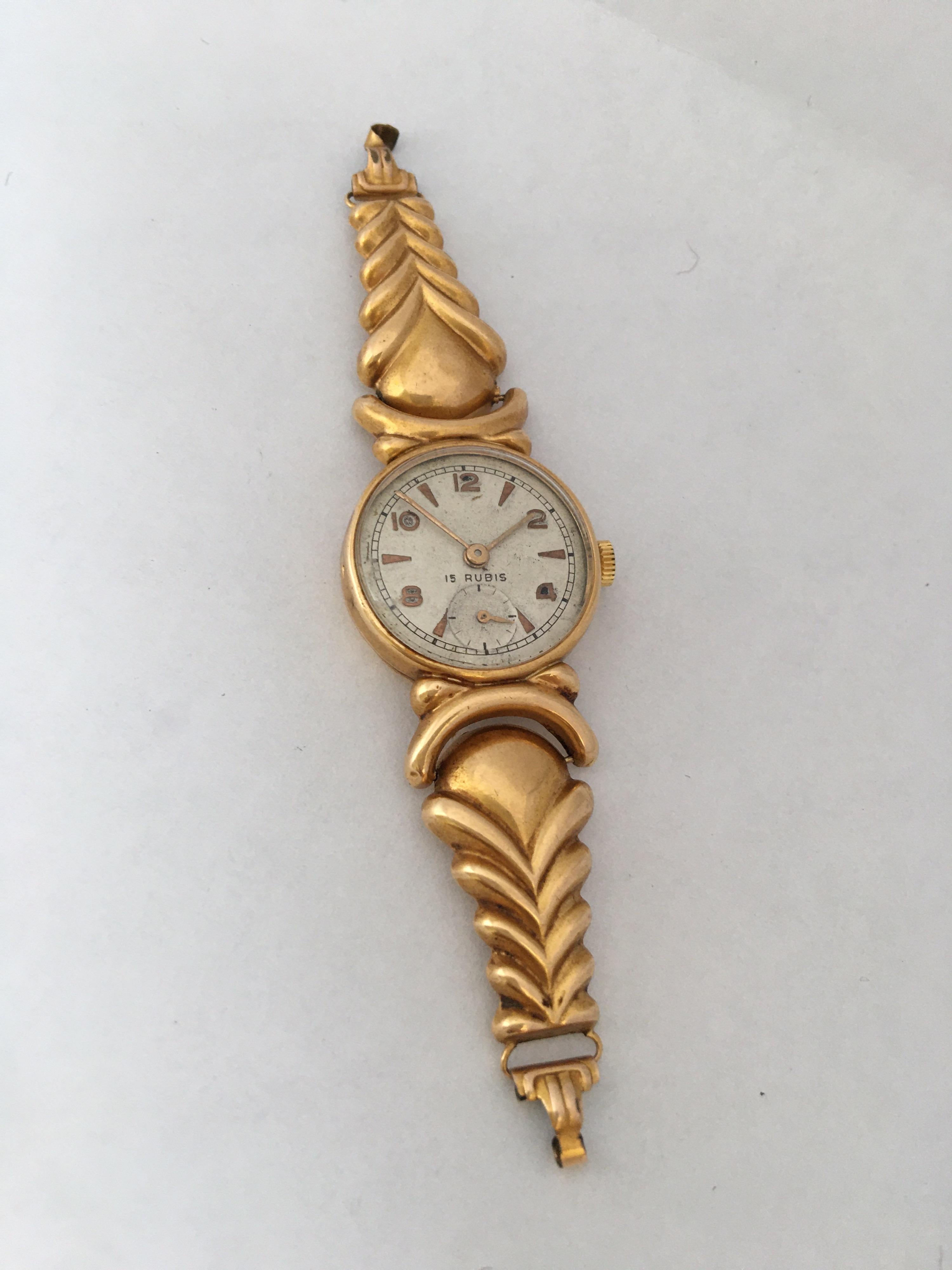 This beautiful vintage gold hand winding watch is working and it is ticking nicely and it runs well. Part of the gold metal strap is missing as shown. The silvered dial is a bit worn. Some Light scratches and dents on the gold watch case as shown.