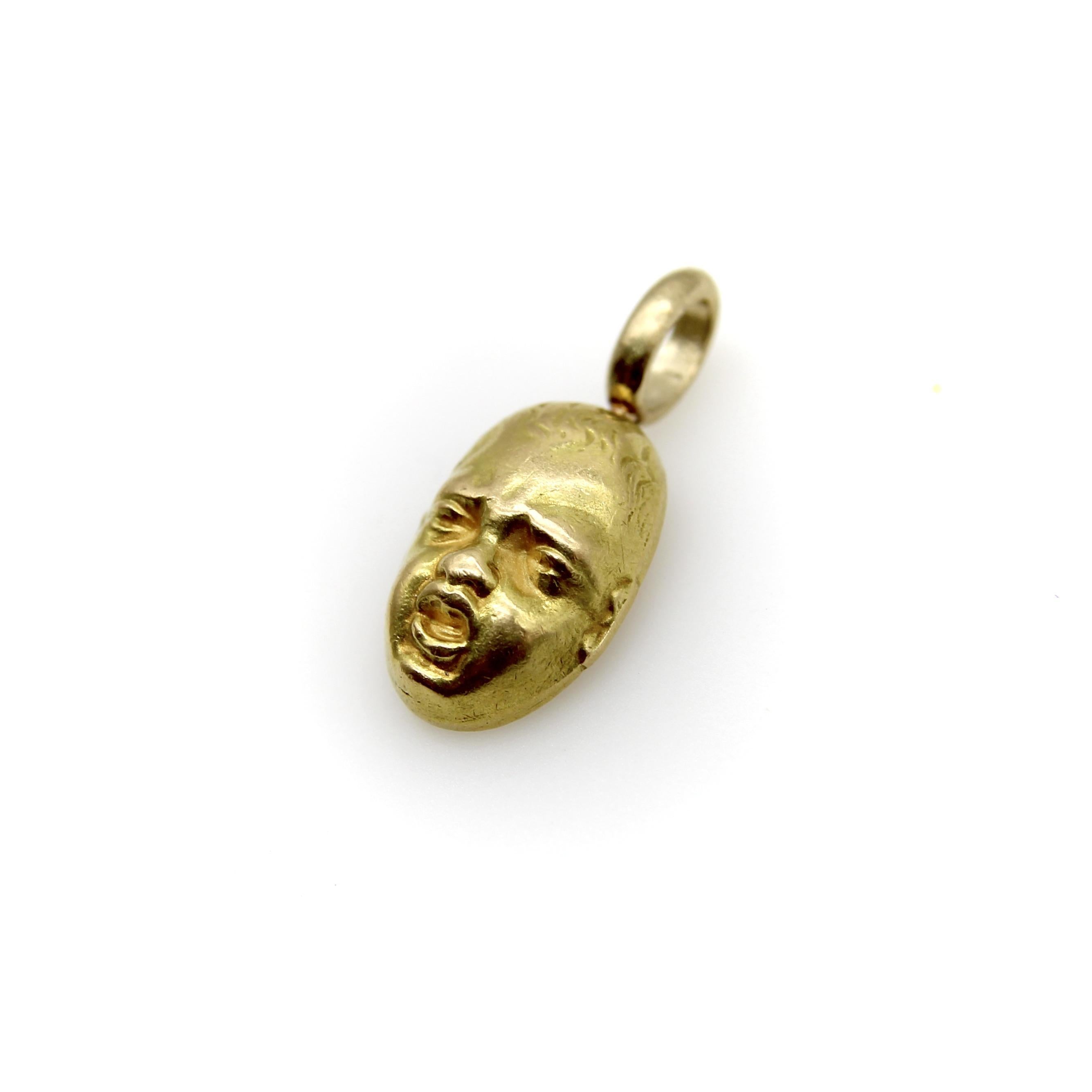 This vintage 18k gold crying baby face charm originally came from a set of cufflinks. We decided to separate the pair and make them individual charms. What we like about it is the level of detail in the face. The crying baby is so well articulated