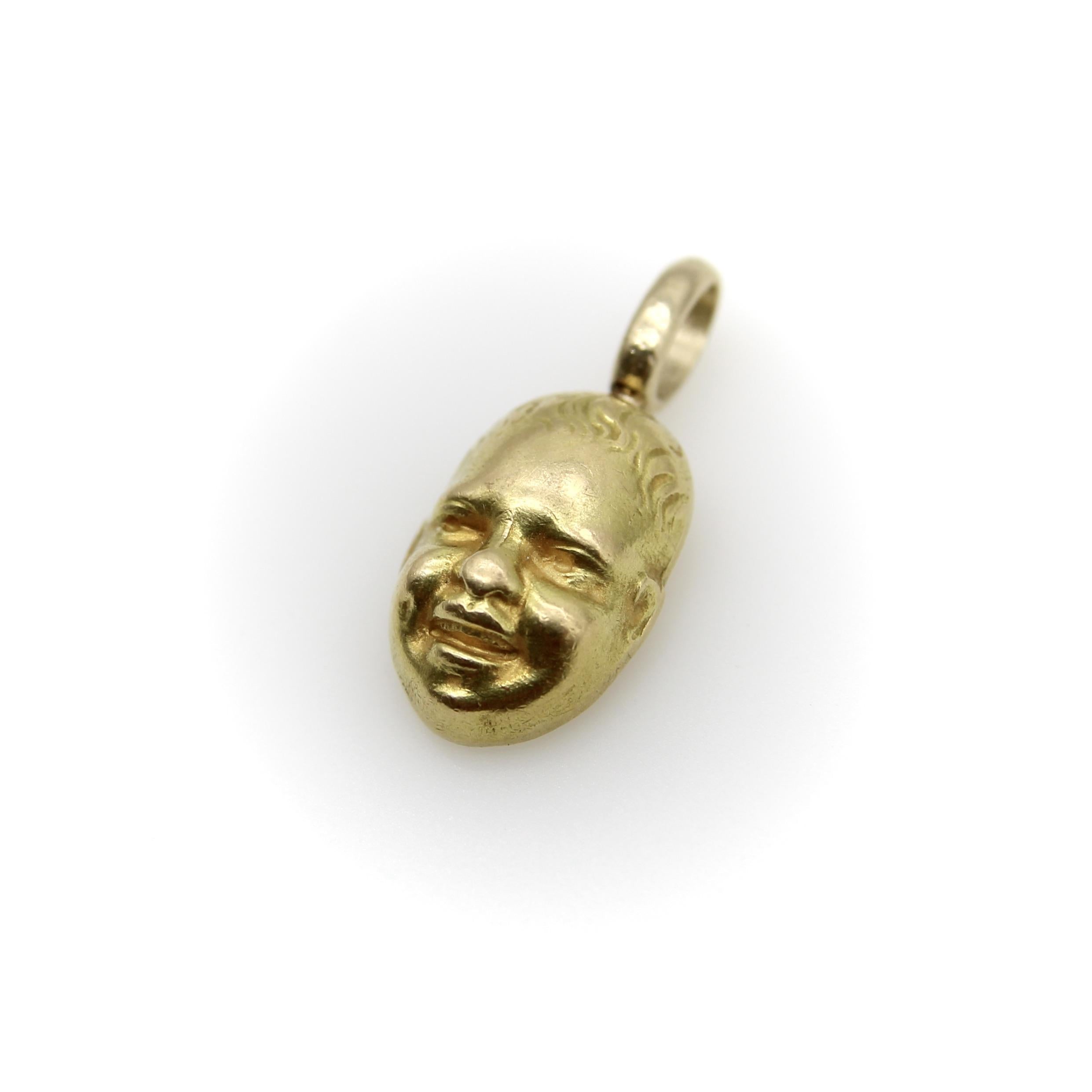 This vintage 18k gold smiling baby face charm originally came from a set of cufflinks. We decided to separate the pair and make them individual charms. What we like about it is the level of detail in the face. The smiling baby is so well articulated