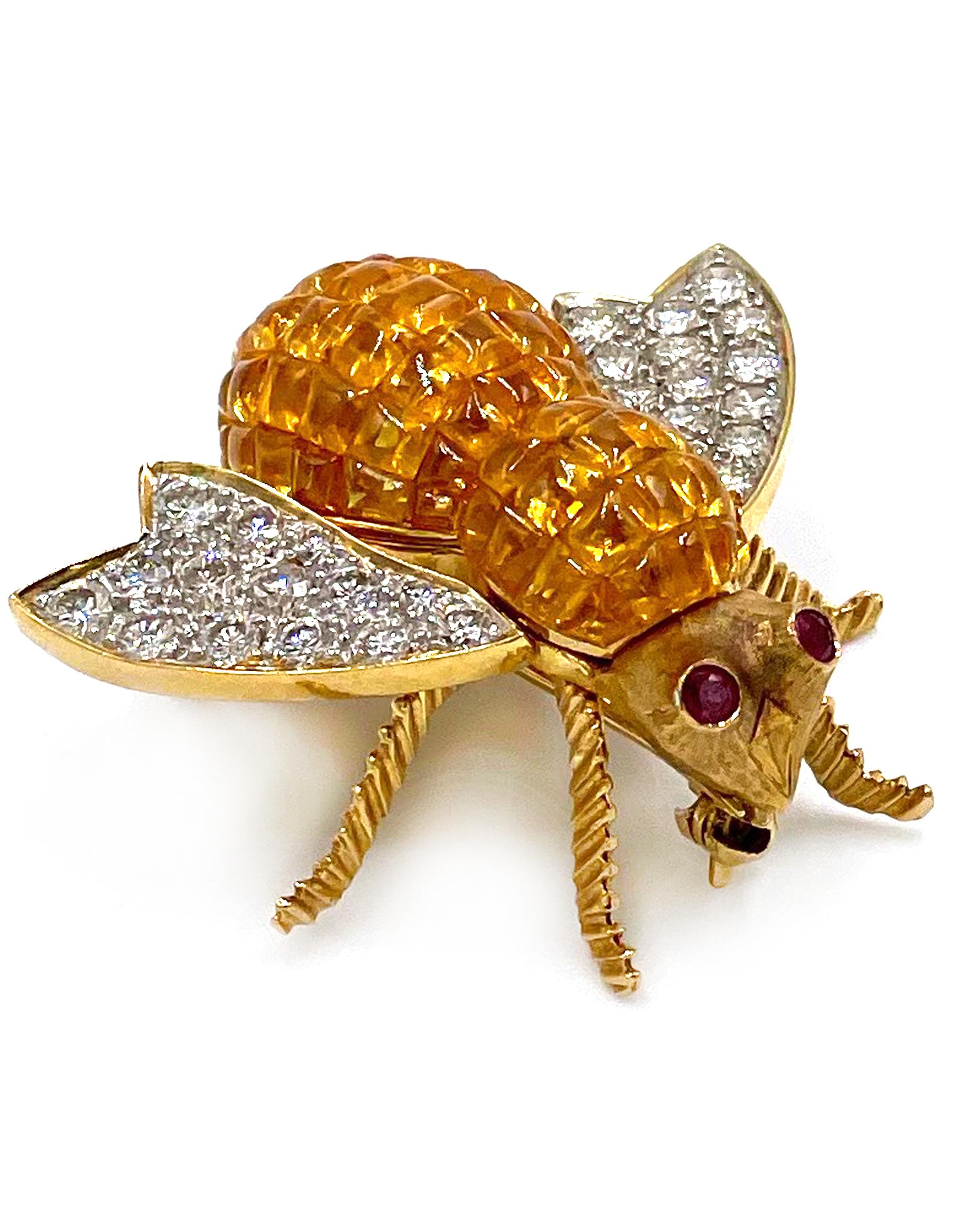 Pre owned vintage estate 18K yellow gold sapphire bee pin.  The body of the bee has 67 invisibly set square cut yellow sapphires with an approximate total weight of 8.71 carats.  Set on both wings are a total of 28 round brilliant cut diamonds with