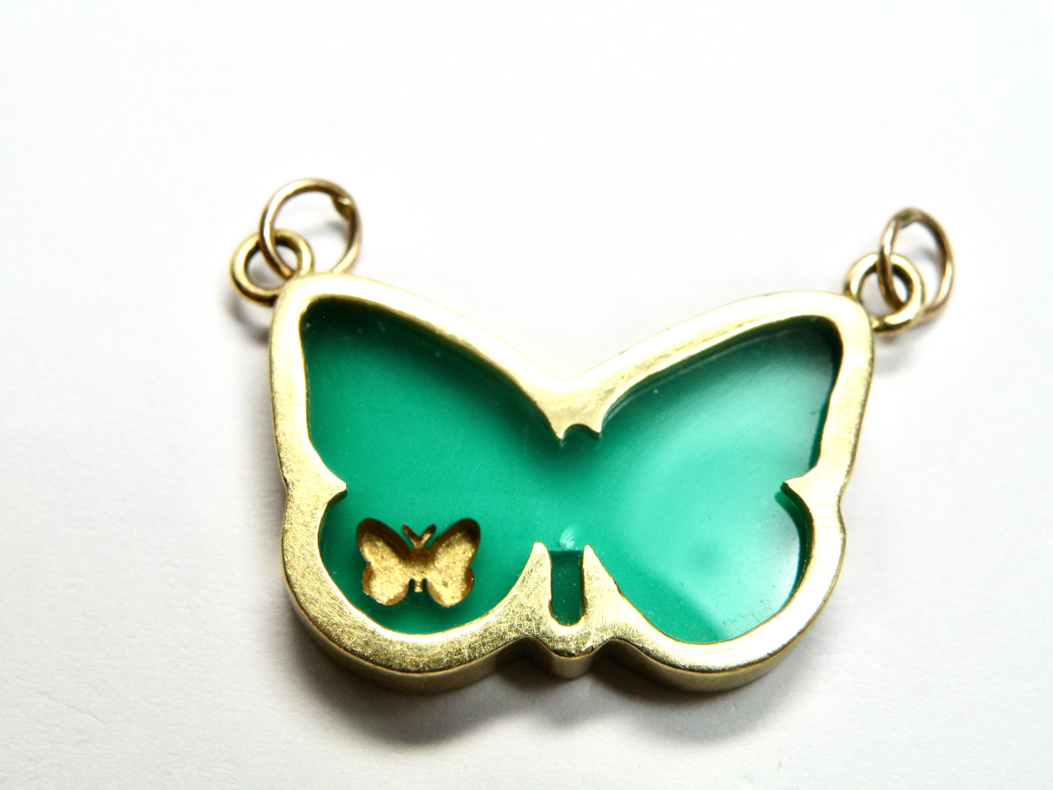 18 karat bezelled butterfly hand carved in green agate.