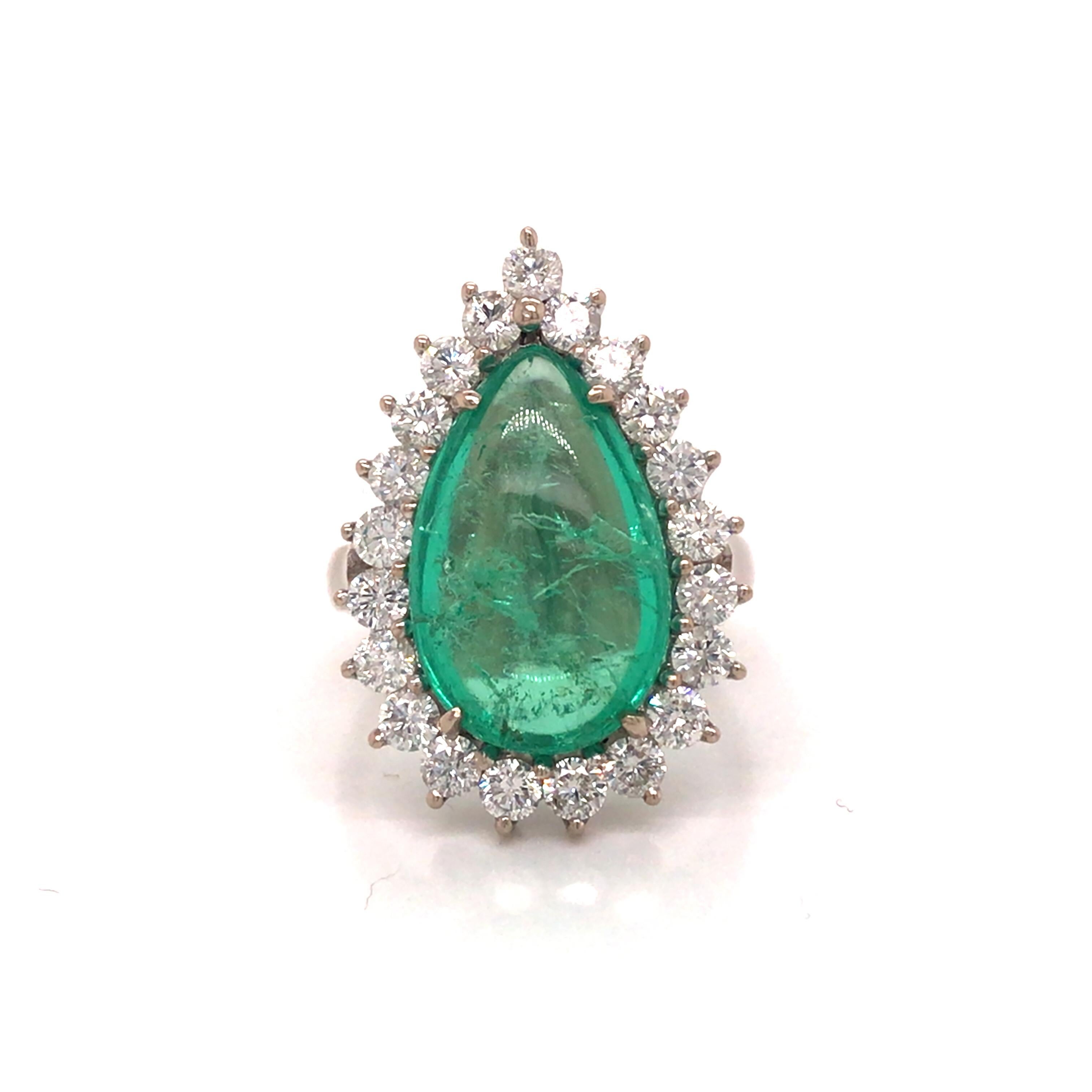 Green Emerald Diamond Halo Ring in 18K White Gold.  Round Brilliant Cut Diamonds weighing 1.54 carat total weight, G-H in color and VS-SI in color are expertly set in a Halo surrounding the 6.0 Carat Pear Shape Green Emerald Center.  The Ring