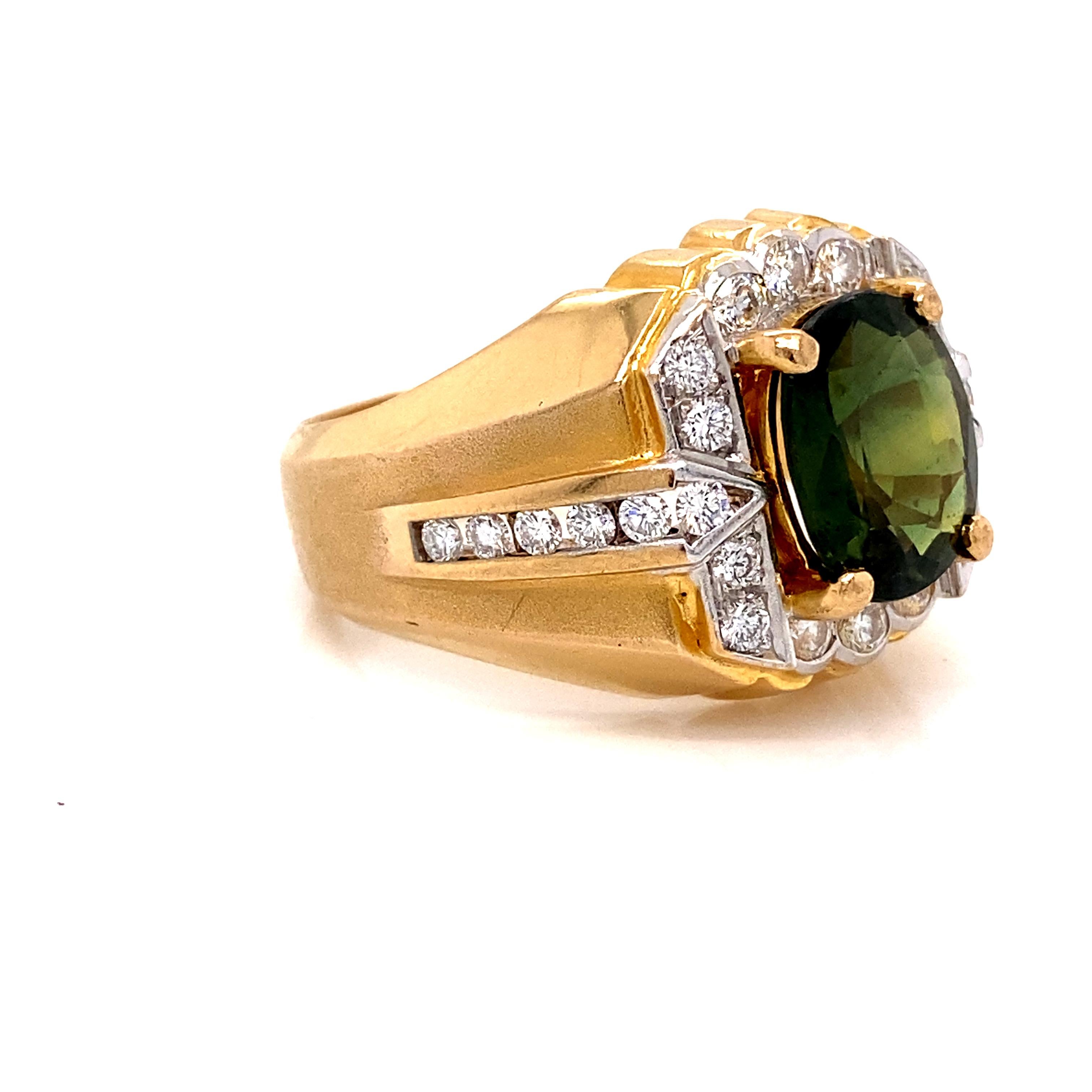 An incredible green sapphire resting among round brilliant diamonds in a bold 18k yellow gold ring. The sapphire weighs approximately 3.83 carats. The diamonds are G-H color and VS2-SI1 clarity. Together, the diamonds weigh approximately 0.82 ctw.