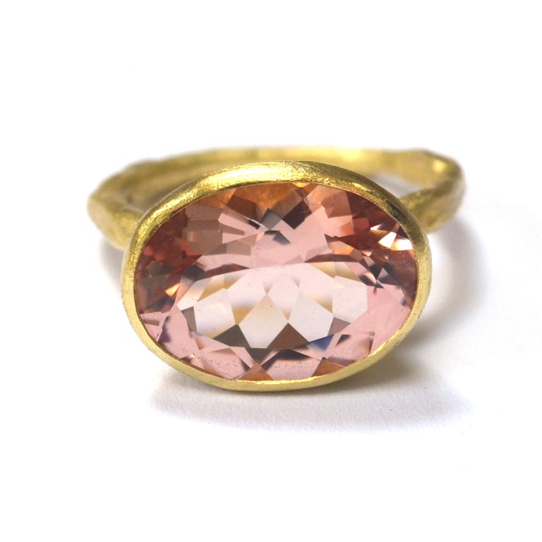 18k yellow gold reticulated melted texture ring with 12mm x 16mm oval 7ct rose hue Morganite. This stone is a particularly desirable shade, framed by a rubover setting that tapers in towards the ring. The setting is 8mm deep. The band is 2.5mm width