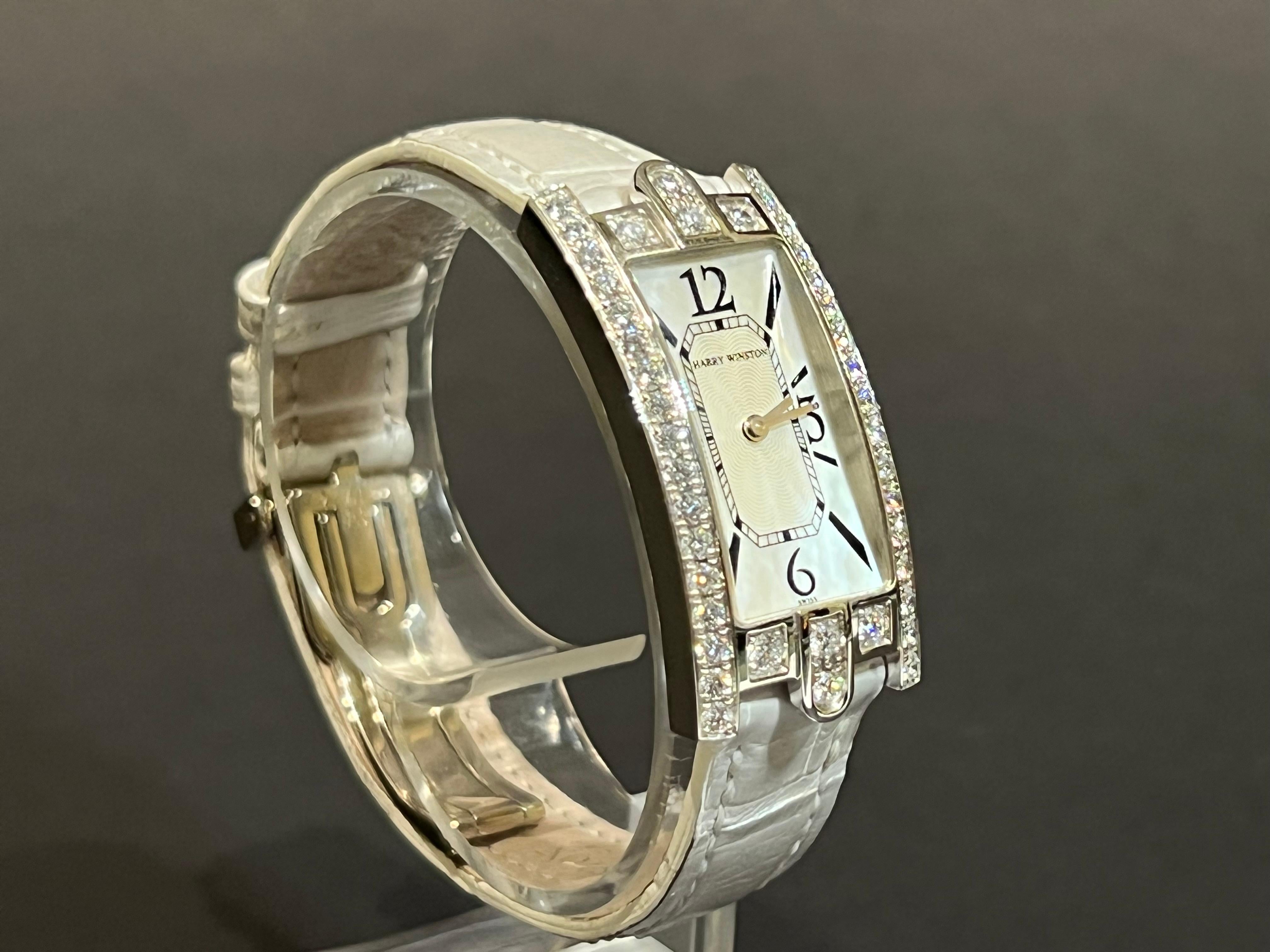 Diamond crown accent. Twice signed 18K and leather bracelet.

Brand: Harry Winston
Type: Wristwatch
Model Name: Avenue
Model Number: 330 LQW
Bezel Material: 18K White Gold
Case Material: 18K White Gold
Case back Material: 18K White Gold
Movement: