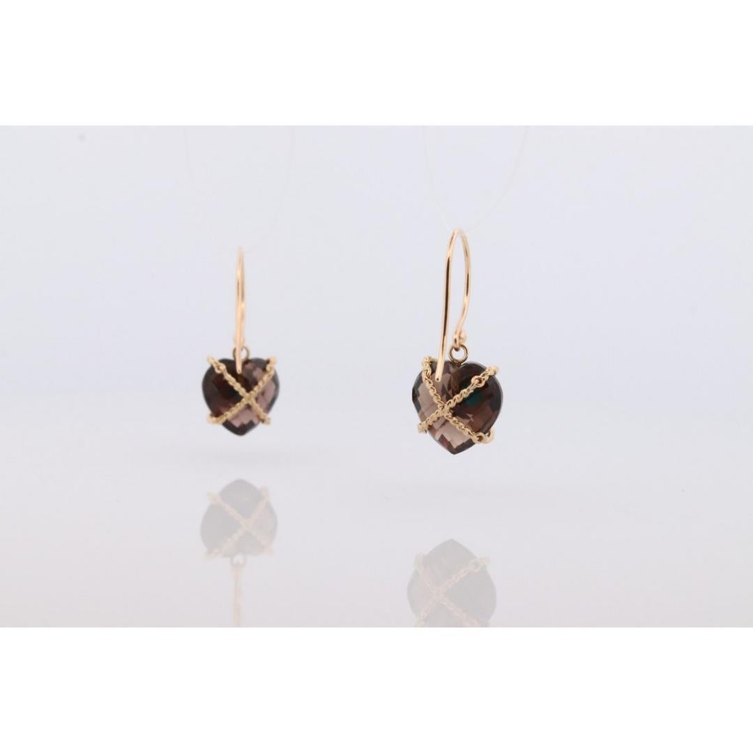 Vintage from the 1980s
Materials: Gold
Gemstone: Quartz

Style: Mid-century

Precious Smoky Quartz Carved Earrings with 18k Binding and a center Turquoise cabochon.

Details:
12mm Smoky Quartz Heart
3mm round turquoise cabochon
4.7grams total