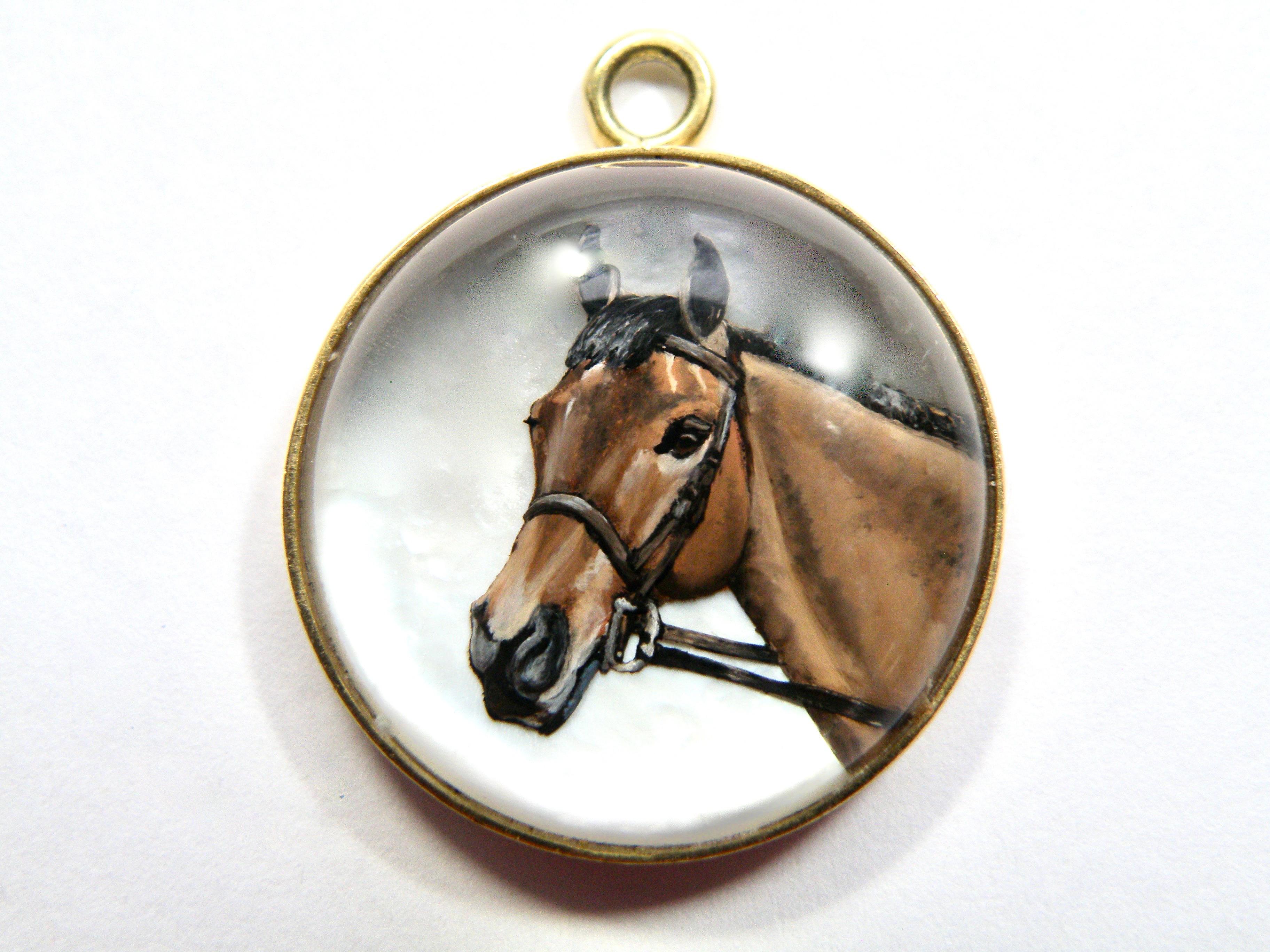 18K hand painted on reverse crystal with mother of pear backing horse with sapphire bail