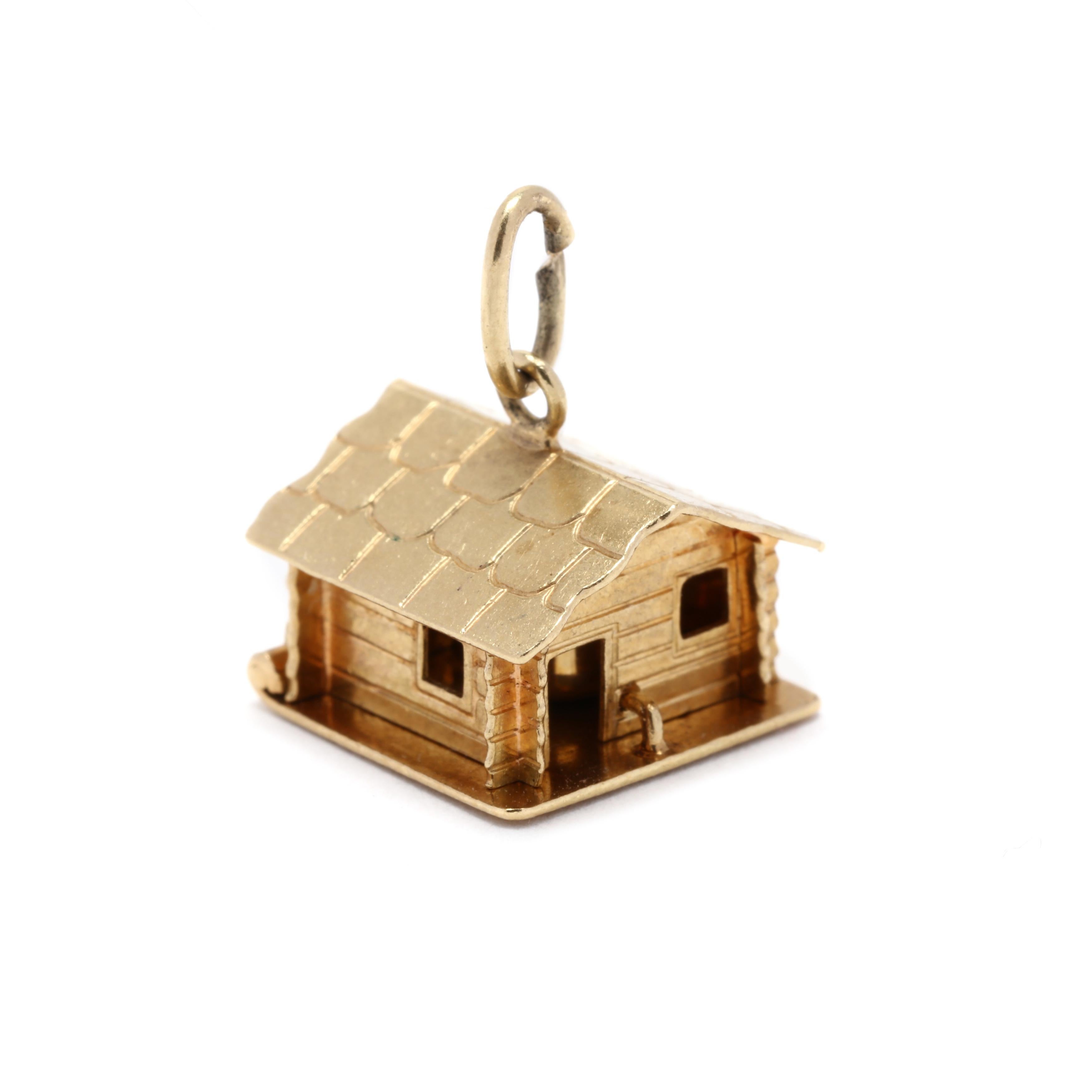 A vintage 18 karat yellow gold house charm with a bucket inside. This house features a wooden motif exterior with open windows and a door, that opens up to reveal a hanging bucket / pale inside.



Length: 1/2 in.



Width: 1/2 in.



Weight: 2.1