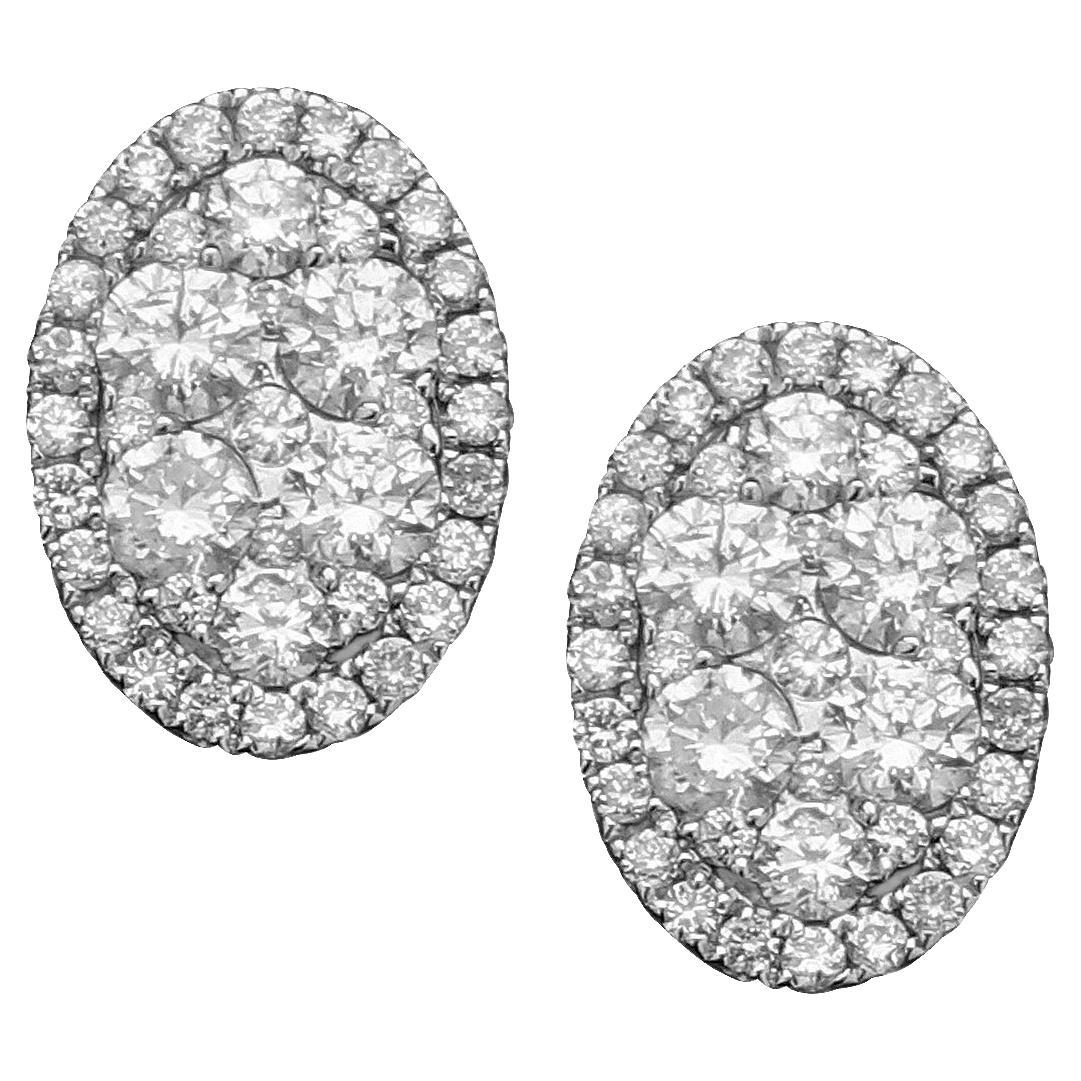 18kw oval studs' earrings with Diamond in white gold perfect matching pair. The illusion of small diamonds together making a big look, these earrings are very cost effective for the look.  Being both elegant and sophisticated, making it a perfect