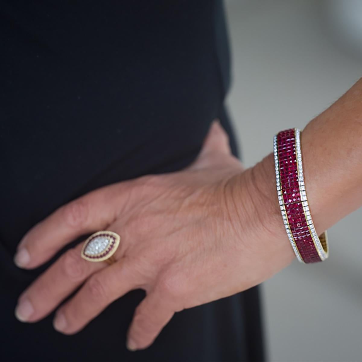 Gorgeous 18k Bracelet set with 312 Invisible set fine rubies weighing approximately 25.00 carats and 156 round fine white diamonds weighing approximately 3.00 carats. 7 1/2