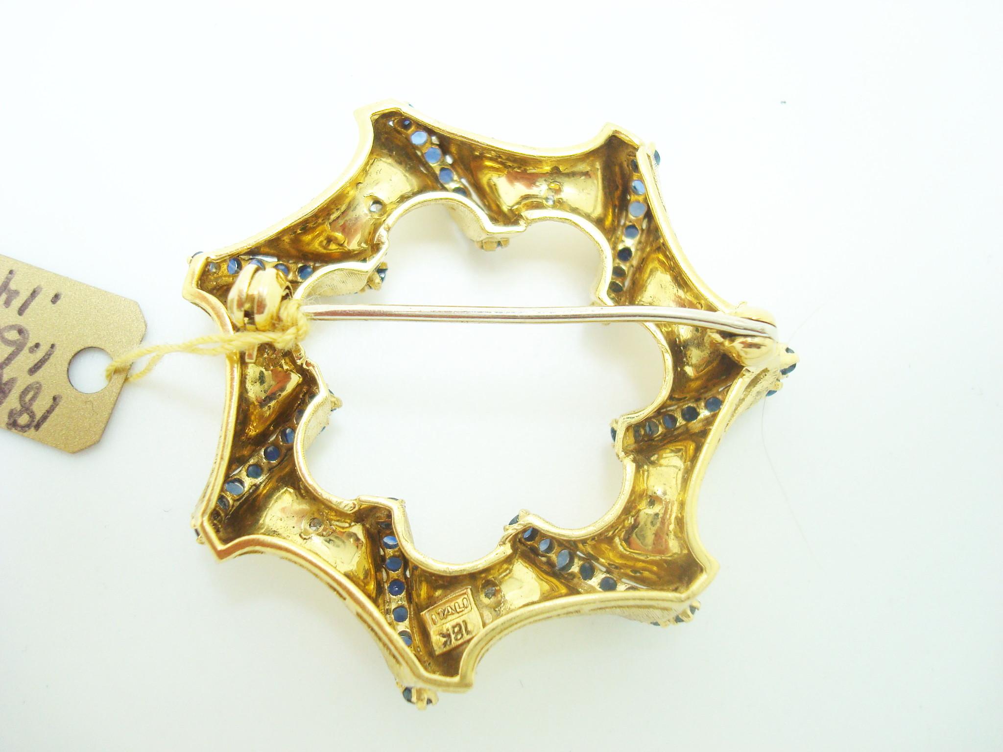 18K ITALIAN BROOCH WITH GENUINE NATURAL BLUE SAPPHIRES AND DIAMONDS (#2390)

Beautifully unique 18K Italian yellow gold brooch that has fabulous small round blue sapphires equaling 1.60 carats and dazzling small round diamonds approximately .14