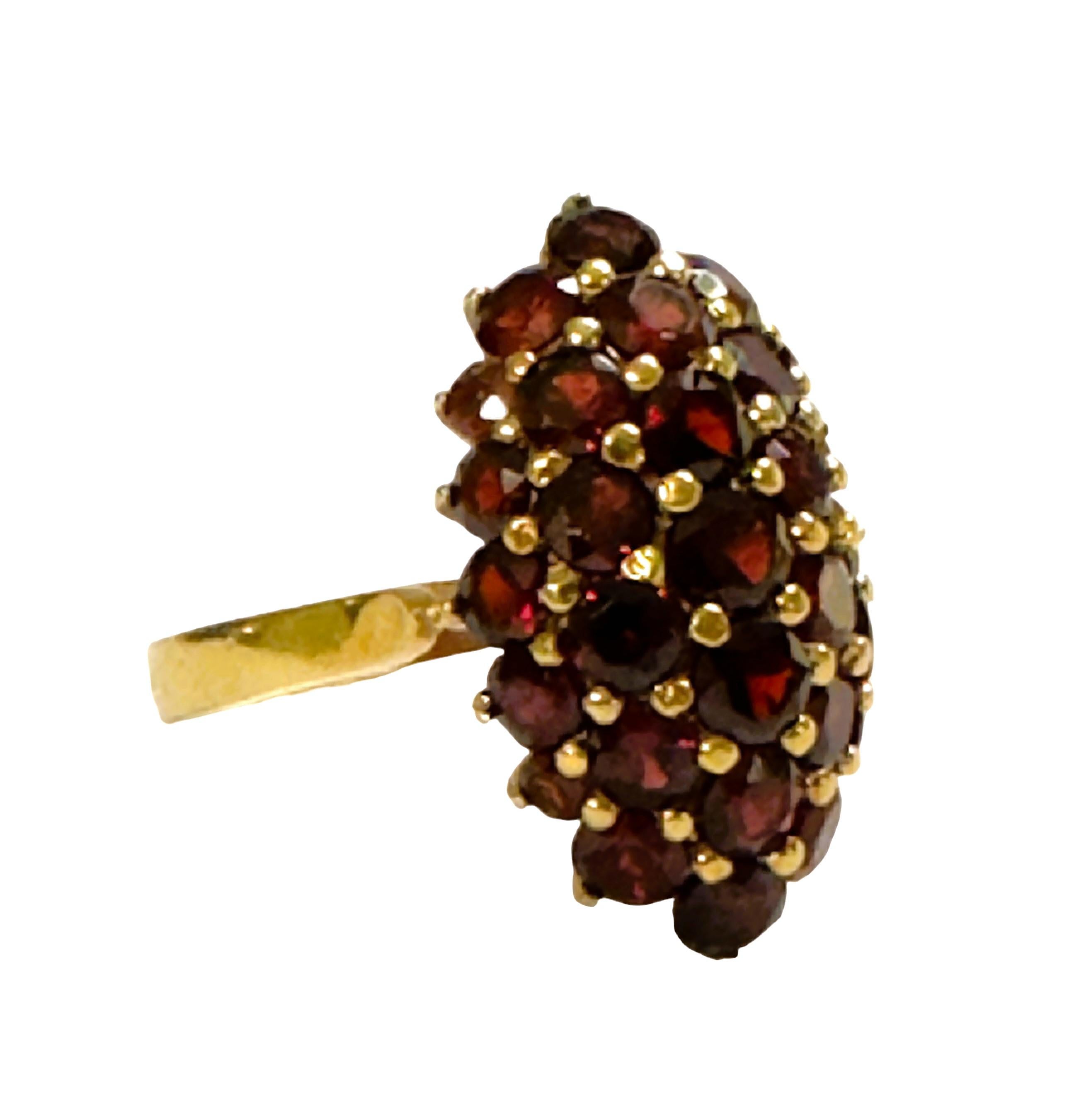 What a cool and unique ring. The Ring is a size 6.5.  Total weight in grams is 6.56.   It has 31 Garnets totaling 3 carats.  Each stone measures between 2 and 3 mm.  The ring is marked 