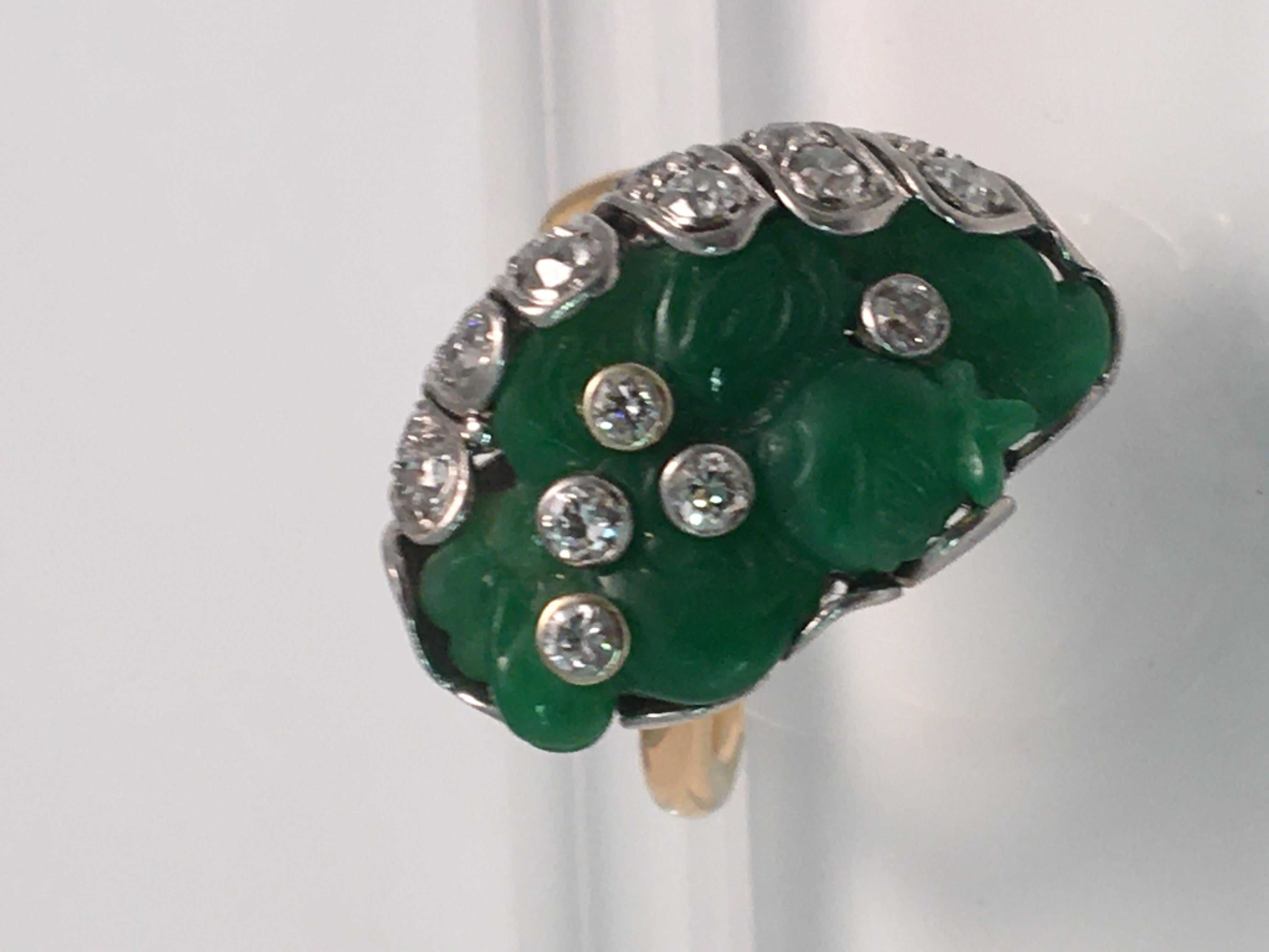 This is a true one-of-a-kind ring that will be the highlight to any outfit!
18 karat yellow and white gold.
Free form green jade approximately 25mm X 14mm X 1.8mm.  Pure green even color.
23 round full cut diamonds, approximately 1.69tdw.
Diamonds