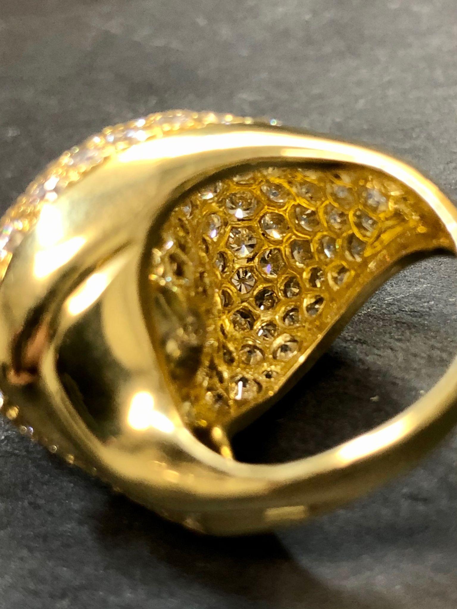 A beautifully made vintage ring by famed jewelry designer Jose Hess (who is no longer with us). It is done in 18K yellow gold and set with approximately 5.85cttw in F-G color and Vs1 clarity diamonds and centered by a 12mm cream colored South Sea