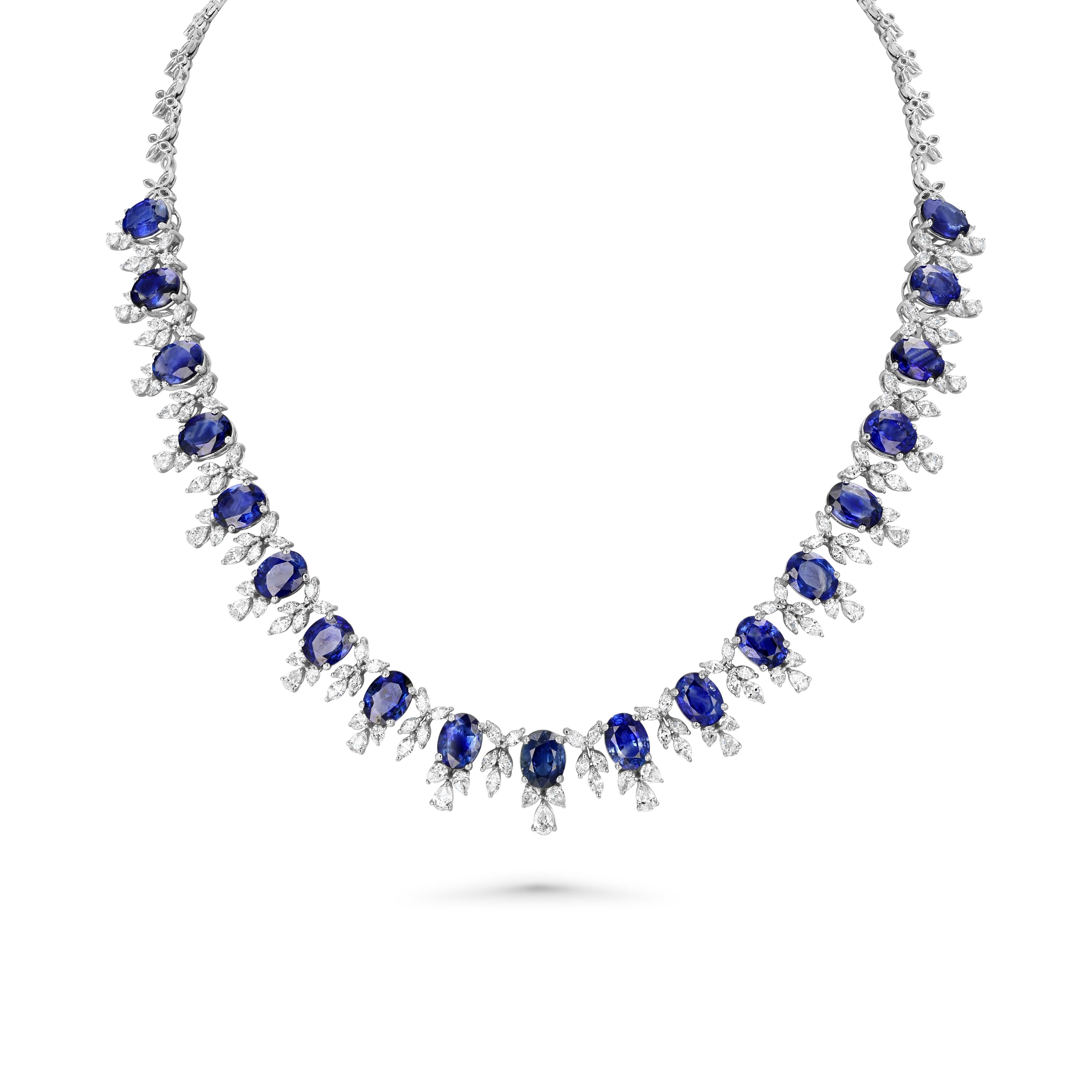 Item #8170

Eighteen karat (18K) white gold natural sapphire corundum and diamond necklace. Oval brilliant cut natural sapphire corundum gemstones are mounted in the center of the necklace. Pear, marquise, and oval brilliant
cut diamonds accent the