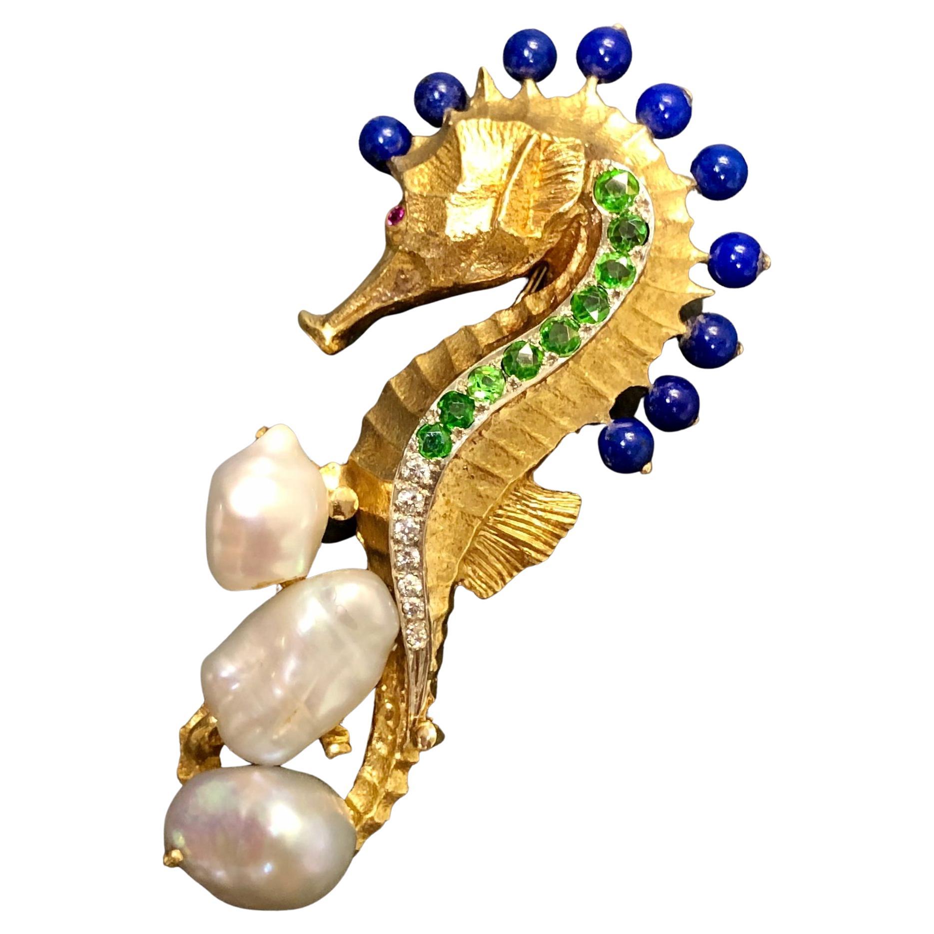 This stunning and detailed piece has been hand crafted in 18K yellow gold and masterfully etched into the magnificent nautical creation you see before you. There are beautifully electric tsavorite garnets, clean white diamonds as well as beads of