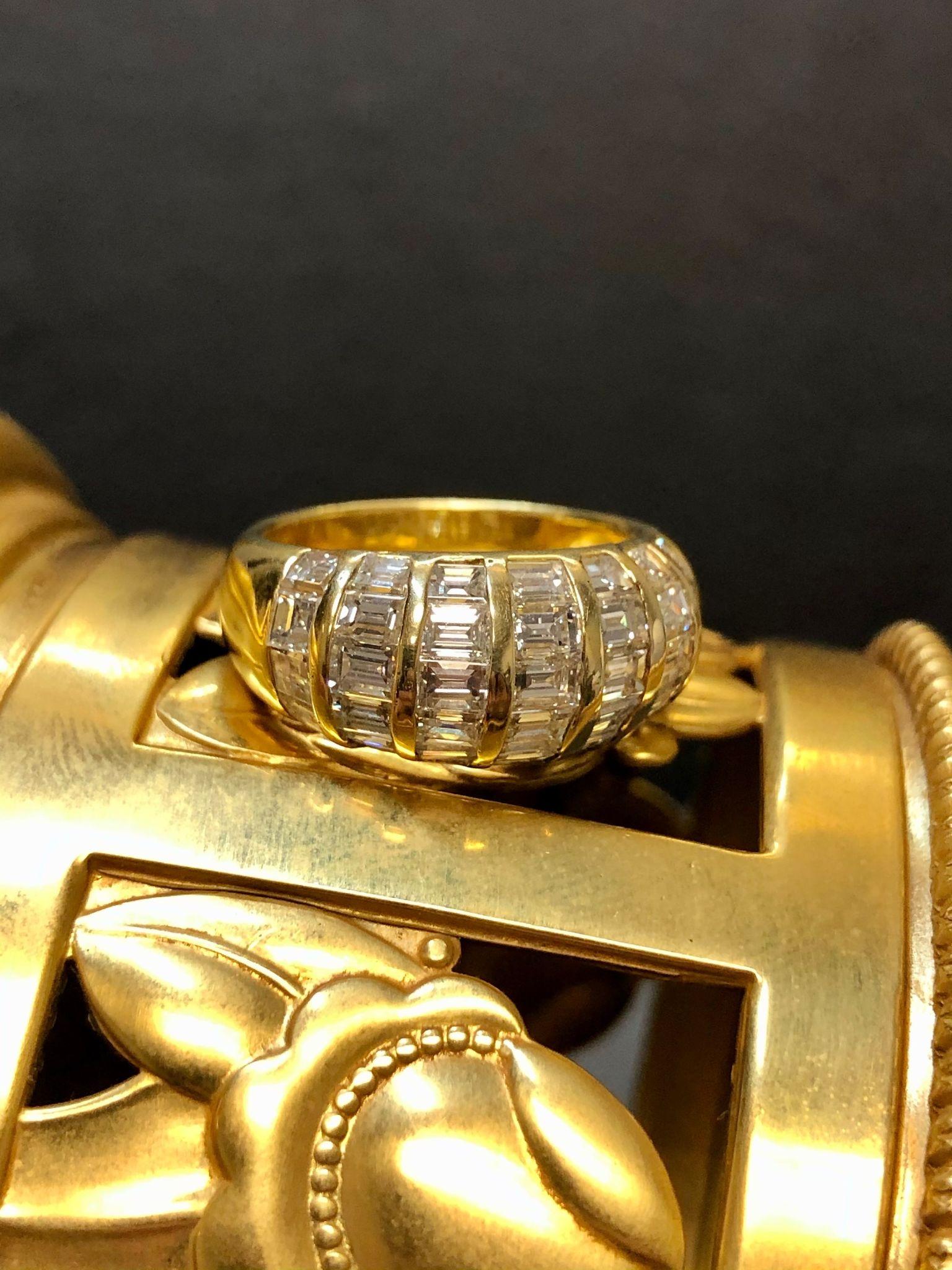 A well made piece done in 18K and channel set with approximately 3.80cttw in G-I color Vs1-2 clarity long and square baguette diamonds.

Dimensions /Weight
.45” at widest point. Size 7 (sizable). Weight is 5.5dwt.

Condition
All stones are securely