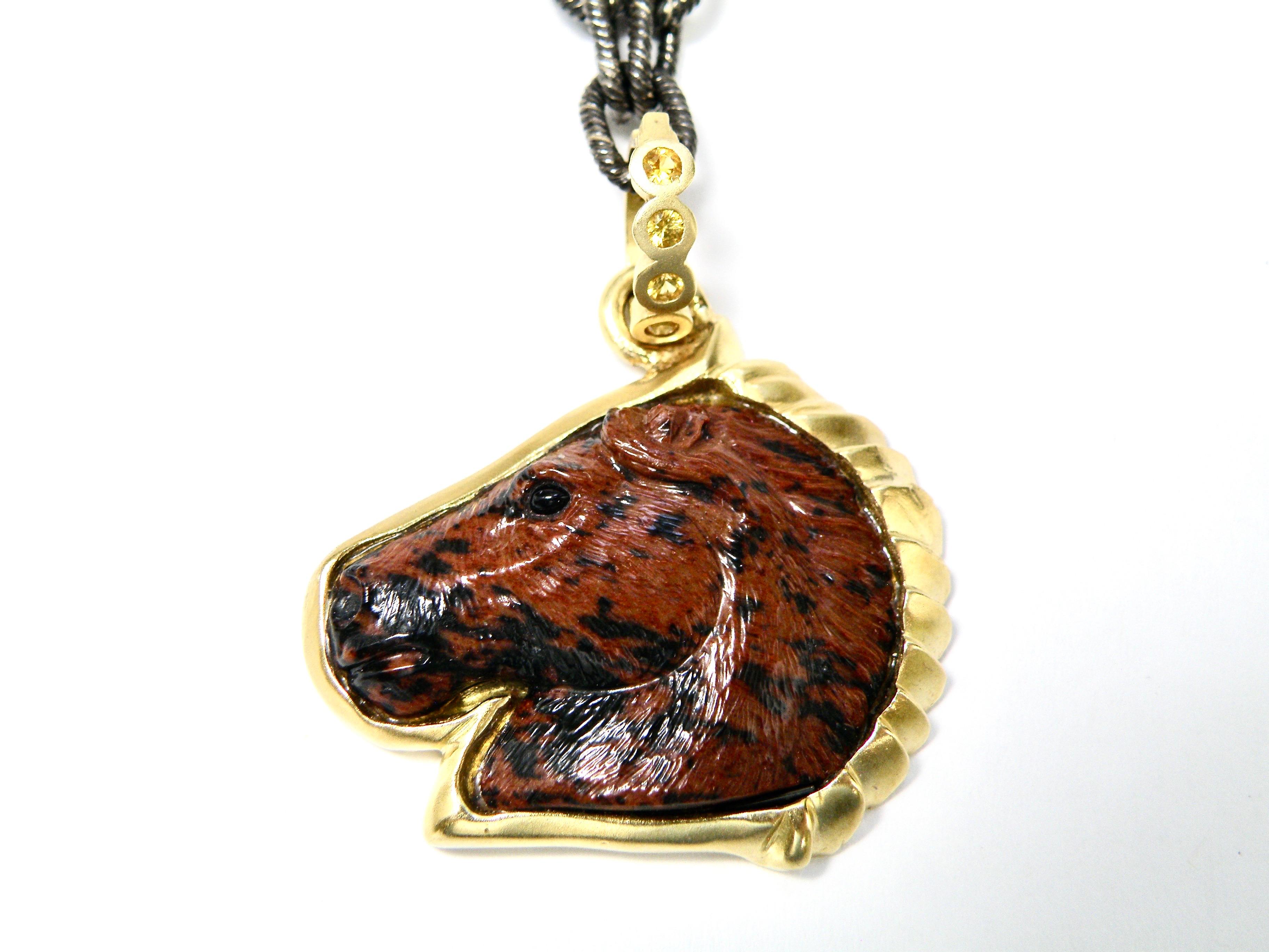 18K hand carved mahogany obsidian horse pendant with .30ct sapphire bail 
28x22x5.6 