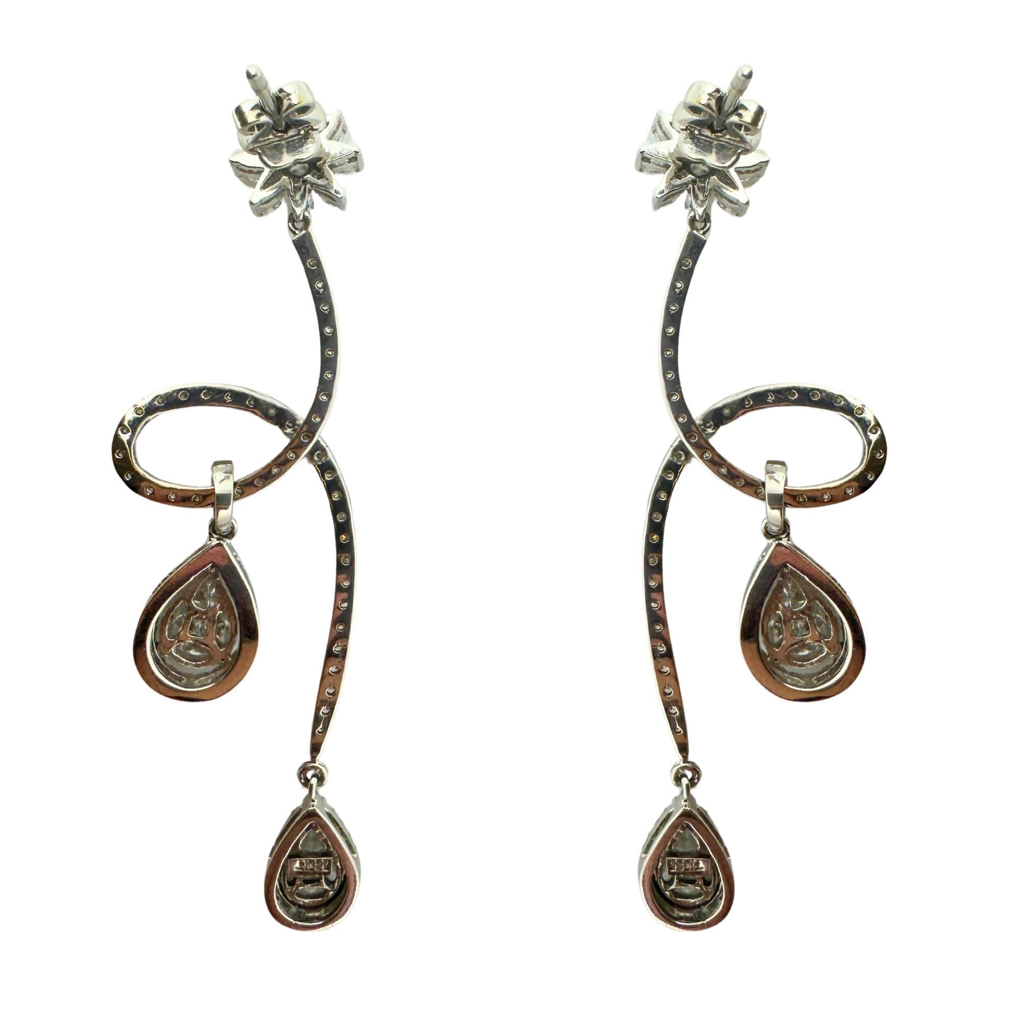 Add these 18k Diamond Earrings to your collection. Crafted with 18k white gold, these earrings feature a total of 1.25 carats of marquise cut diamonds, 0.79 carats of pear cut diamonds, and 1.76 carats of sparkling diamond accents. At 2.5 inches in