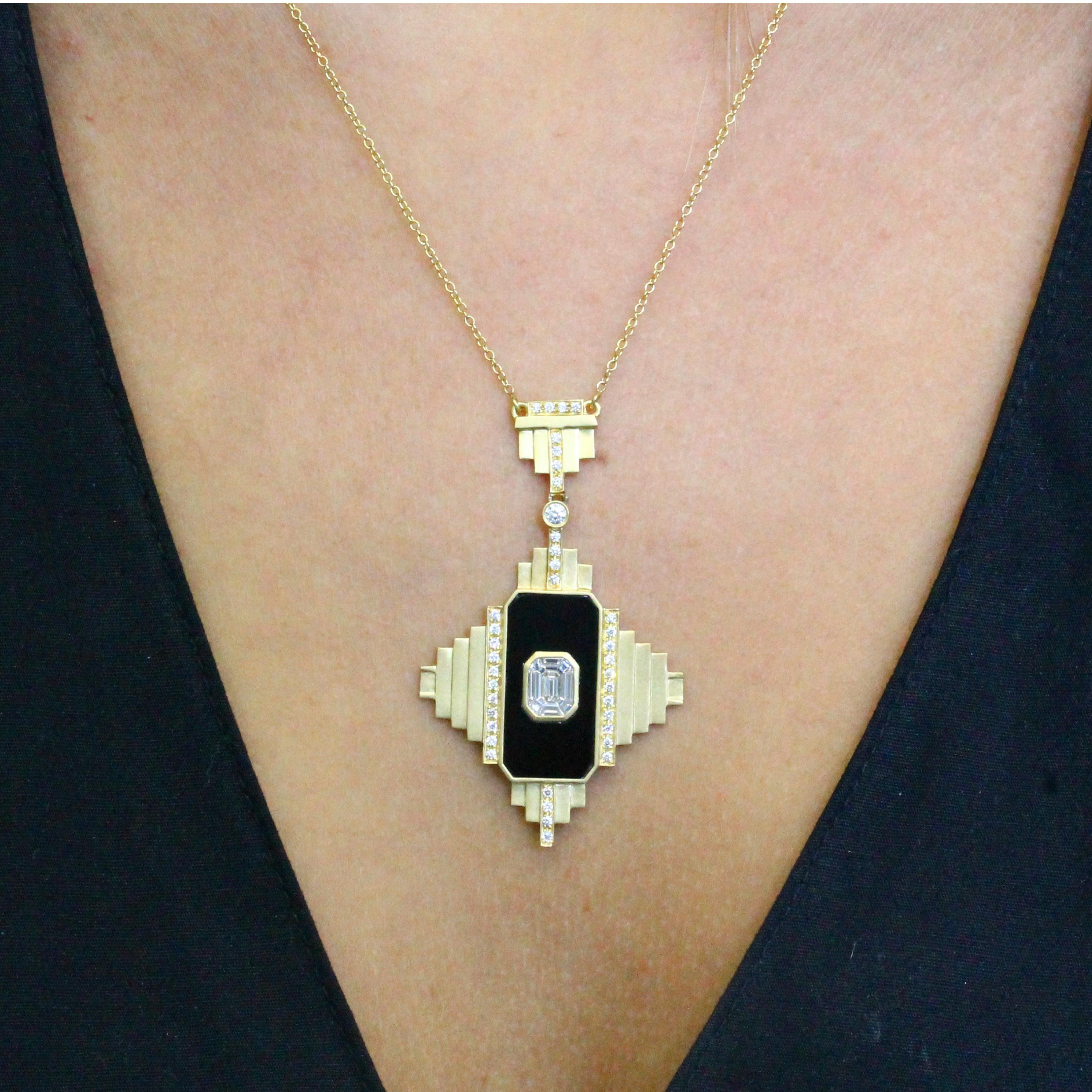 One-of-a-Kind Necklace featuring an Invisible-Set Emerald Diamond Center made up of Baguettes, framed in Black Onyx, in an 18K Yellow Gold Art-Deco style setting, hanging on an 18-inch Chain with 16-inch adjuster. Round Diamond Accents. Black Onyx