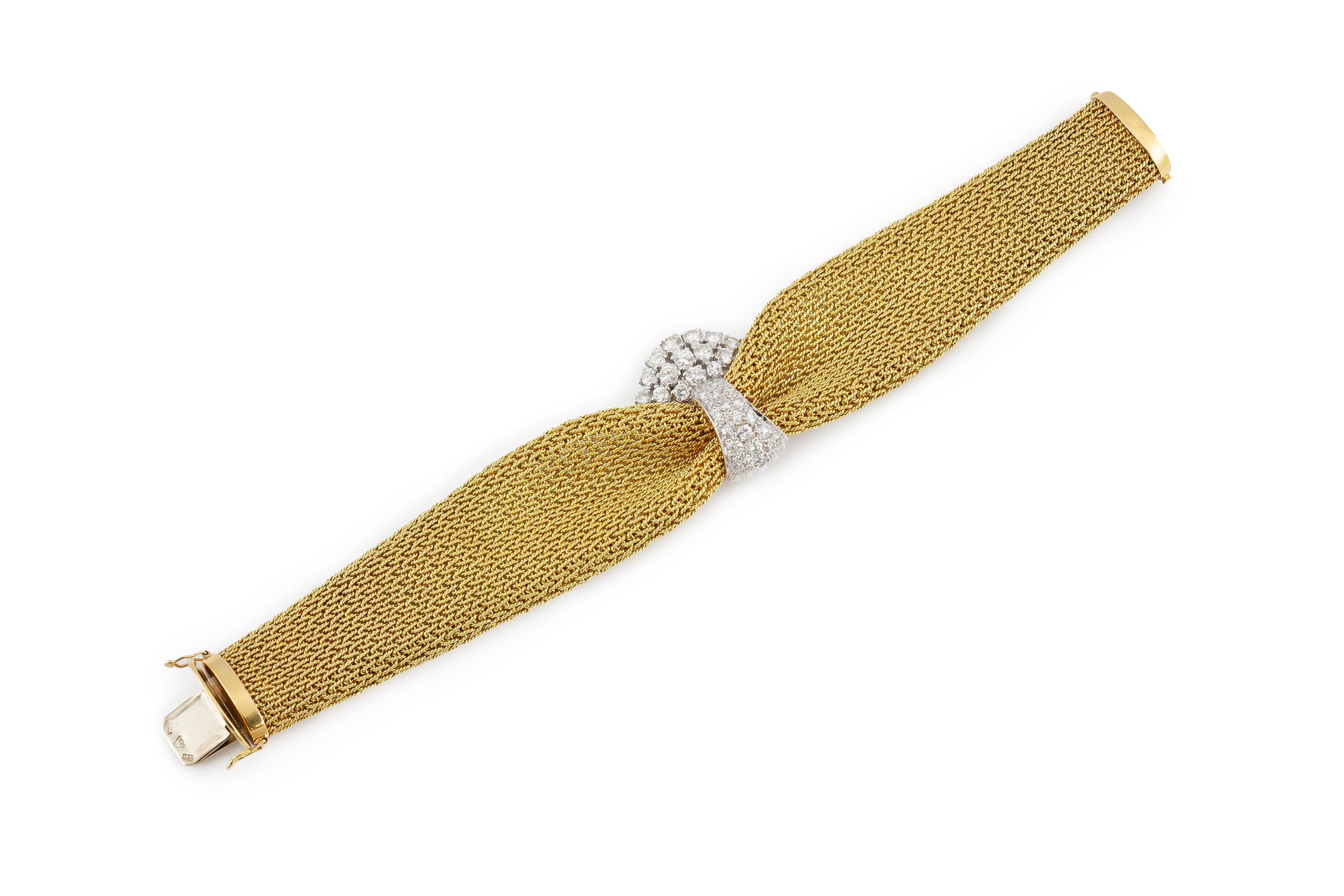 The bracelet is finely crafted in 18k yellow gold with with 2.50 carat center diamonds .