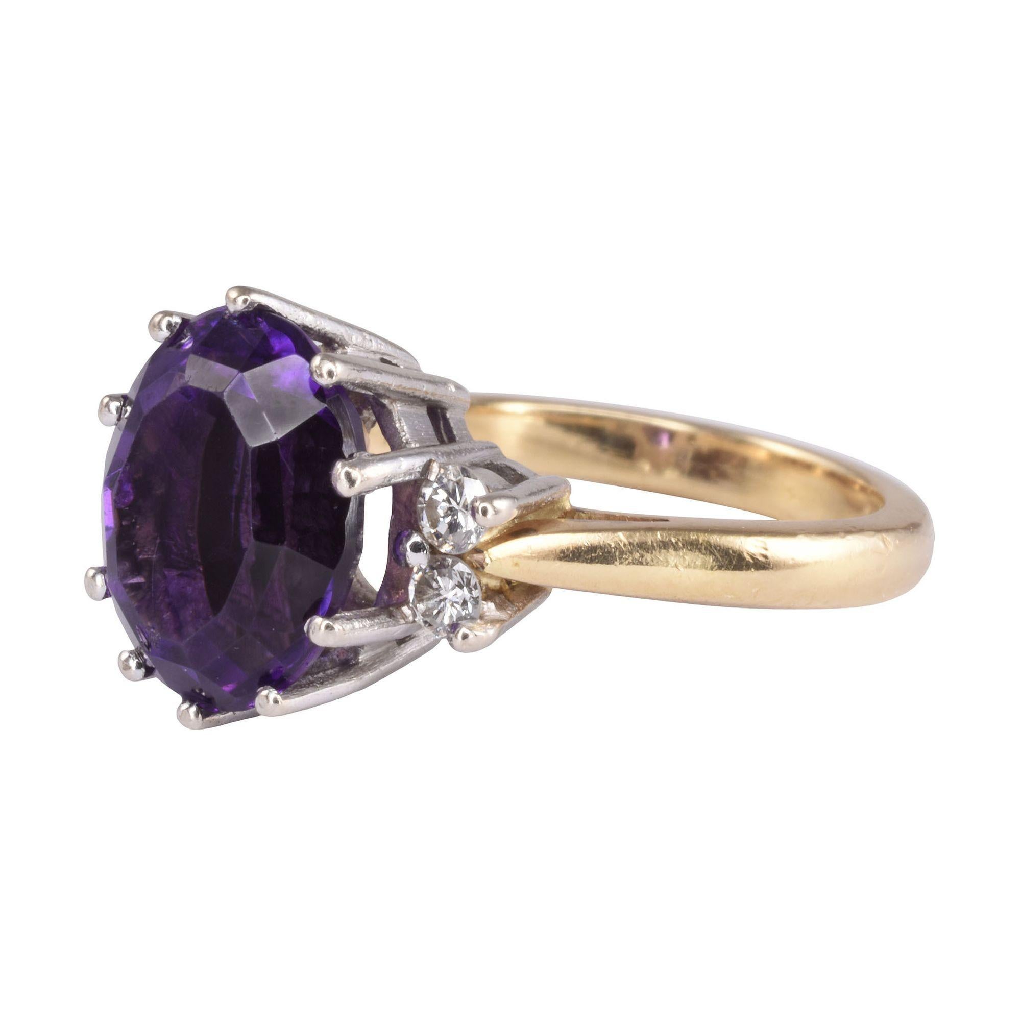 Vintage English 18K mixed cut amethyst ring, dated 1977. This vintage ring is crafted in 18 karat gold and features a 3.0 carat oval mixed cut amethyst with a deep, amazing color. The accent diamonds have VS clarity and I-J color. This vintage