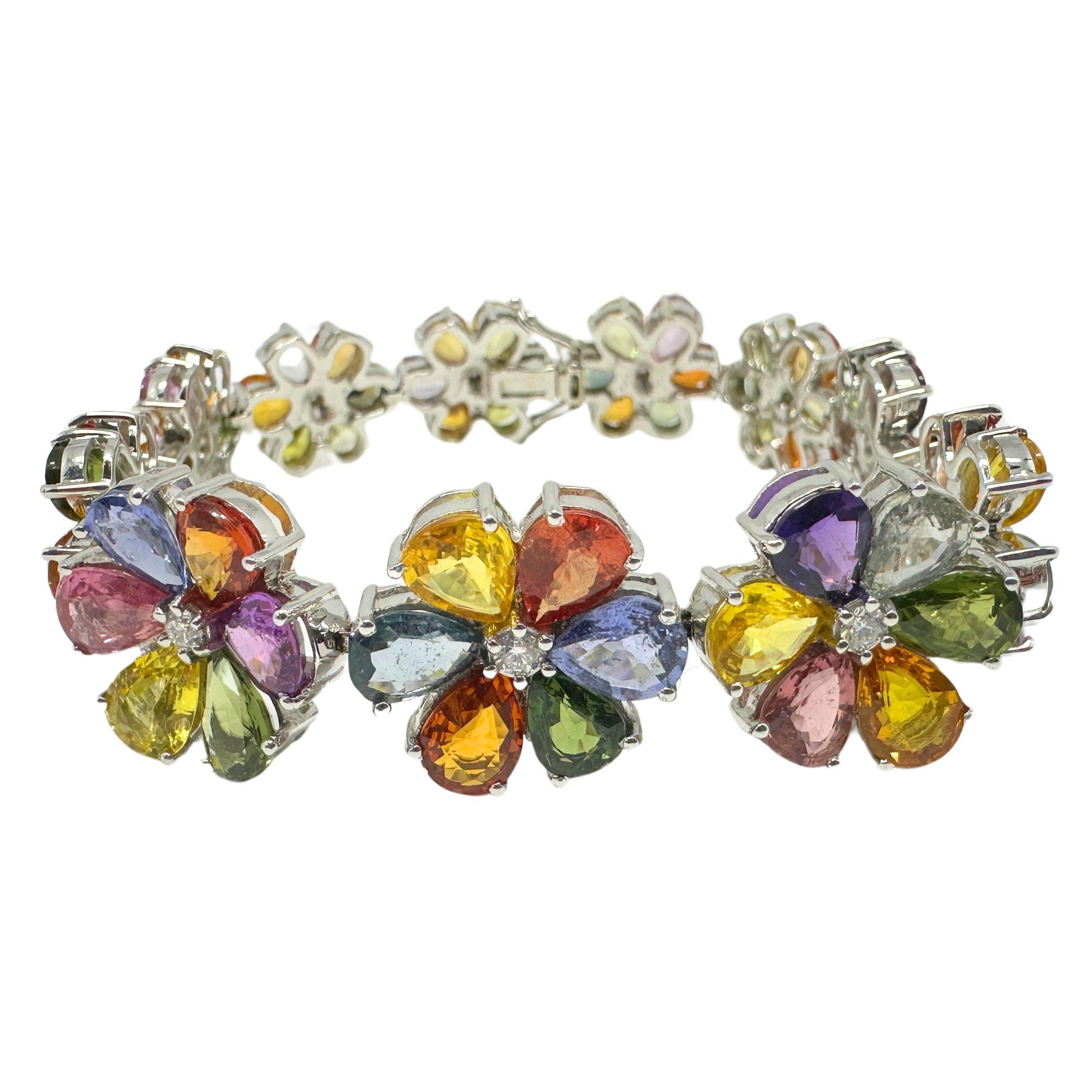 This stunning 18k White Gold bracelet features modern pear cut multicolor sapphires and diamonds. Boasting a total weight of 56.09 carats of sapphires and 0.52 carats of diamonds, this bracelet is a true showstopper. With a length of 7.5 inches and