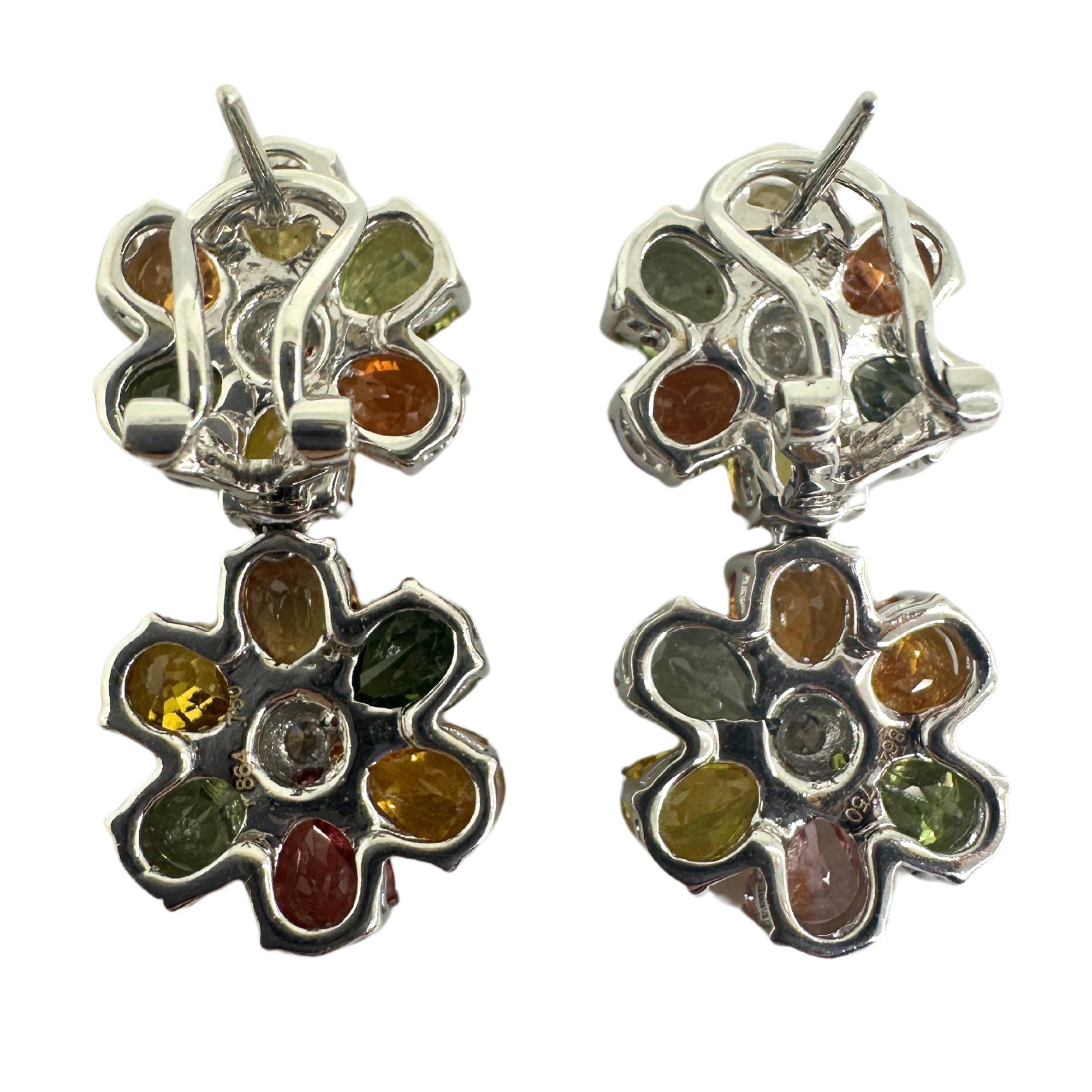 Showcasing these vibrant 18k Modern Multicolor Sapphire and Diamond Flower Earrings! Crafted with 18k white gold, these earrings feature a total of 18.07 carats of multicolor sapphires, surrounded by sparkling 0.21 carat diamonds. Measuring 1.25