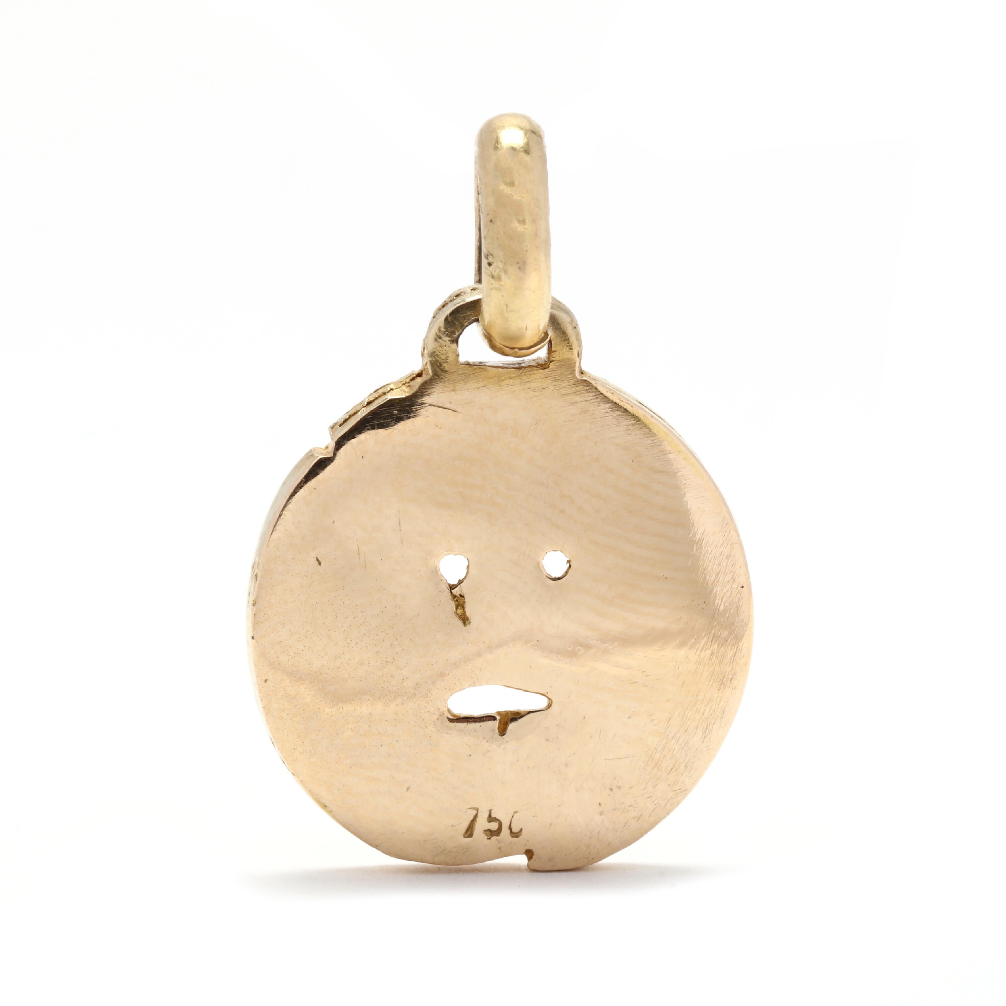 A vintage 18 karat yellow gold Mouth of Truth charm. This charm features a round carved charm that depicts a Mouth of Truth motif. Roman mythology says that if a liar puts their hand in its mouth then it will be bitten.



Length: 1 in.



Width: