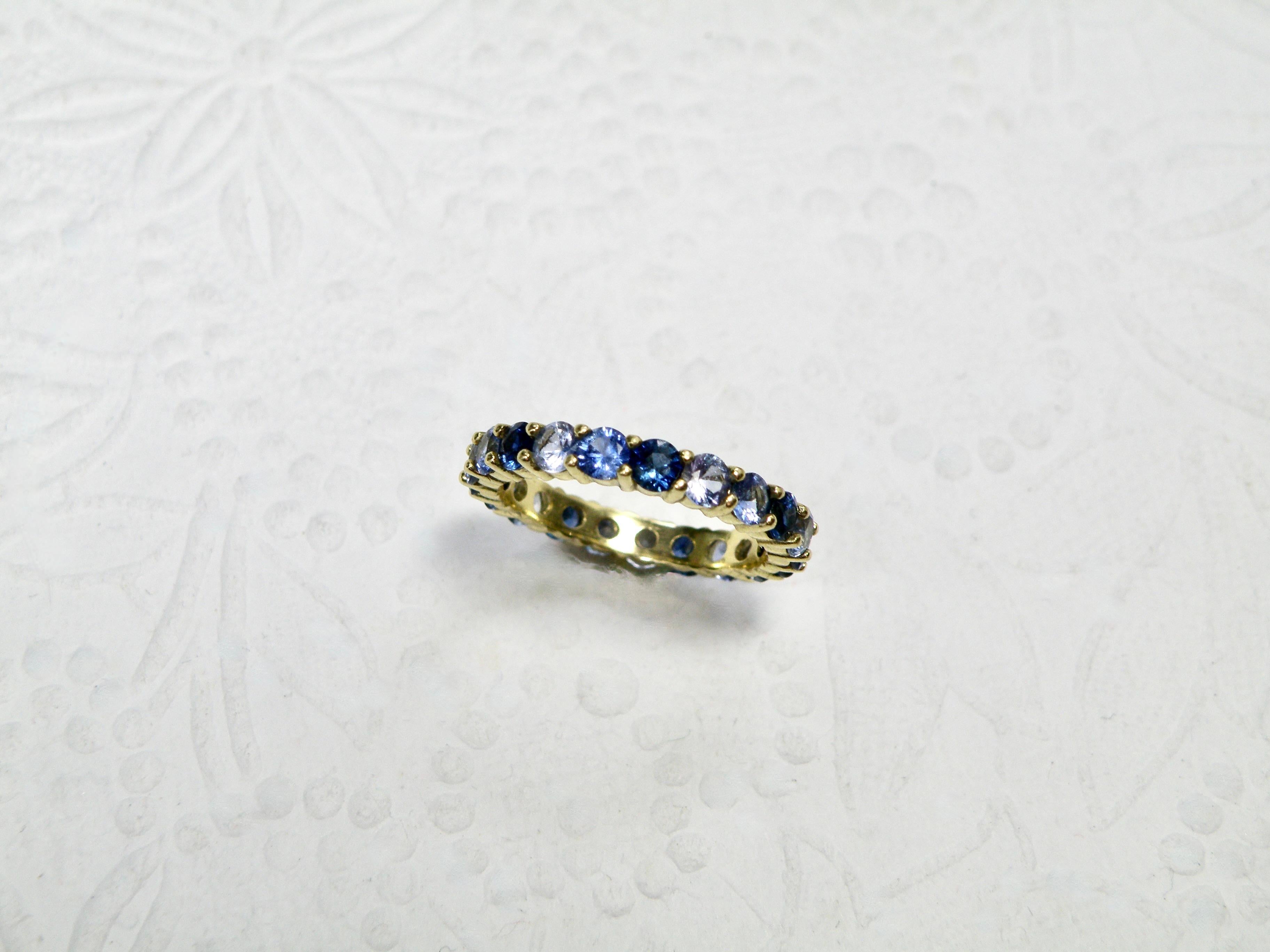 18k ring with multi shades of blue sapphires.