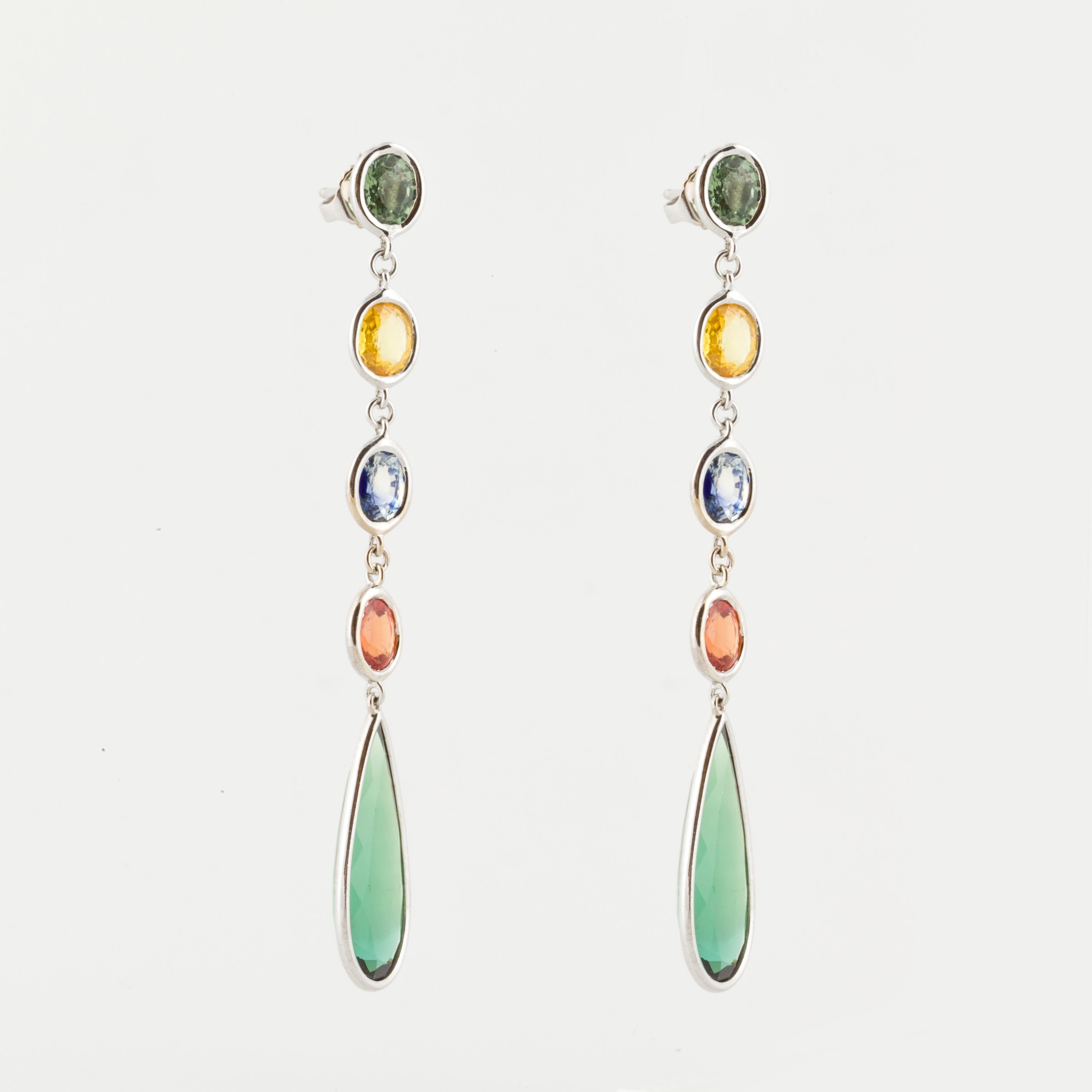 18K white gold drop earrings featuring green, yellow, blue and orange faceted bezel-set sapphires which total 4.50 carats.  The bottom drops are faceted pear-shaped green tourmalines that total 9.80 carats.  Measure 2 3/4 inches long and 3/8 inches