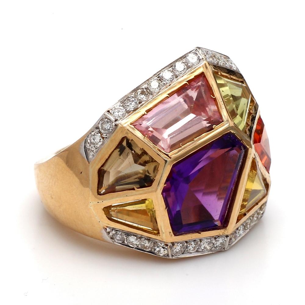 18K yellow gold, cocktail ring.  Ring is set with nine (9) fancy, geometric cut gemstones and thirty-four (34) round brilliant cut diamonds weighing approximately 0.50ctw. Ring weighs 16.3 grams and is a size 7.75. 
All questions answered.
All