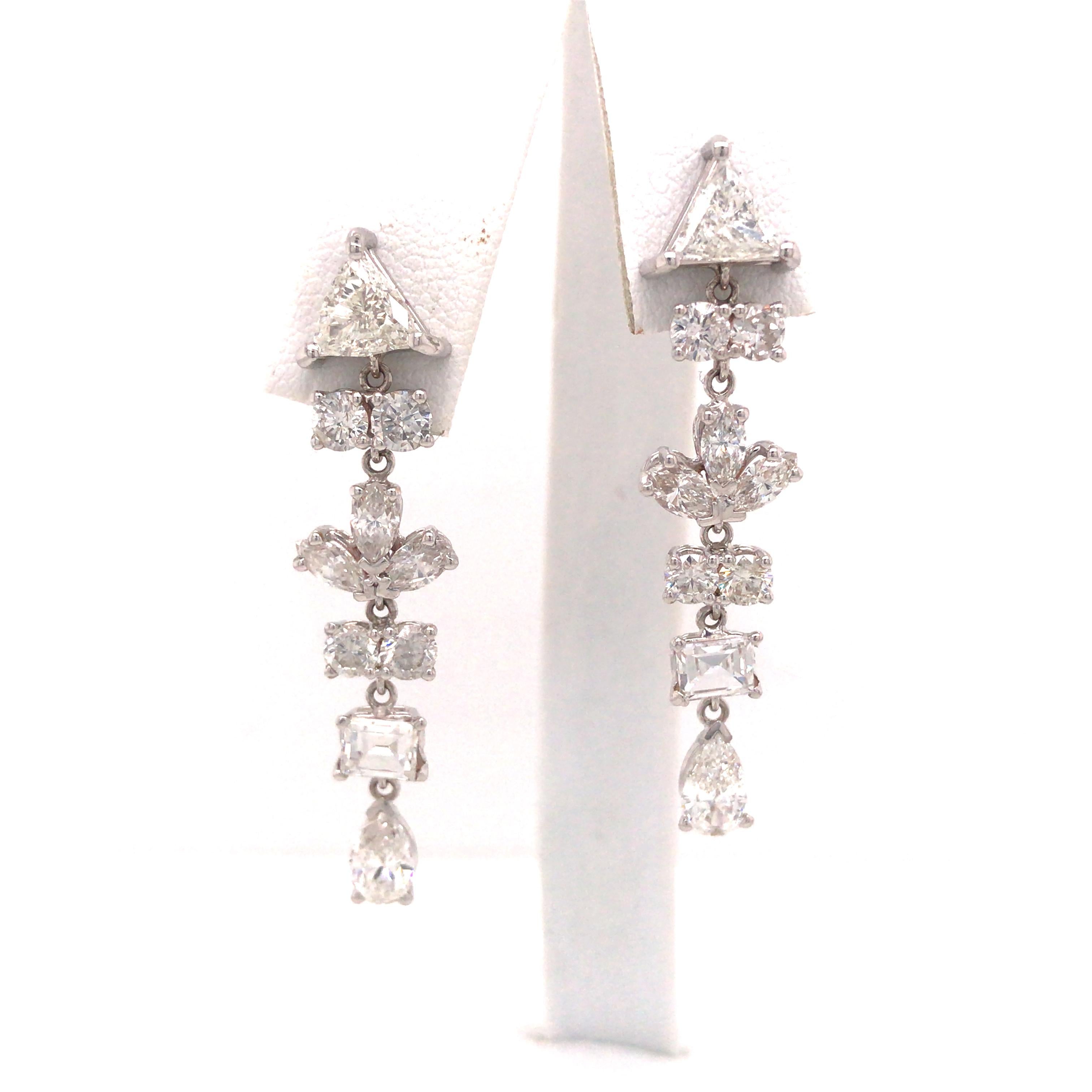 Multi Shape Diamond Hanging Earring in 18K White Gold.  (8) Round Brilliant Cut, (2) Trillion, (6) Marquise, (2) Baguette and (2) Pear Shape Diamonds weighing 4.82 carat total weight, G-I in color and VS-SI in clarity are expertly set.  The Earrings
