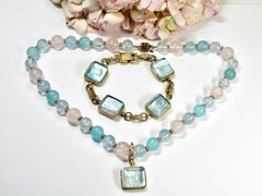 18k necklace with gold spacers and various colored chalcedony, pink and aqua