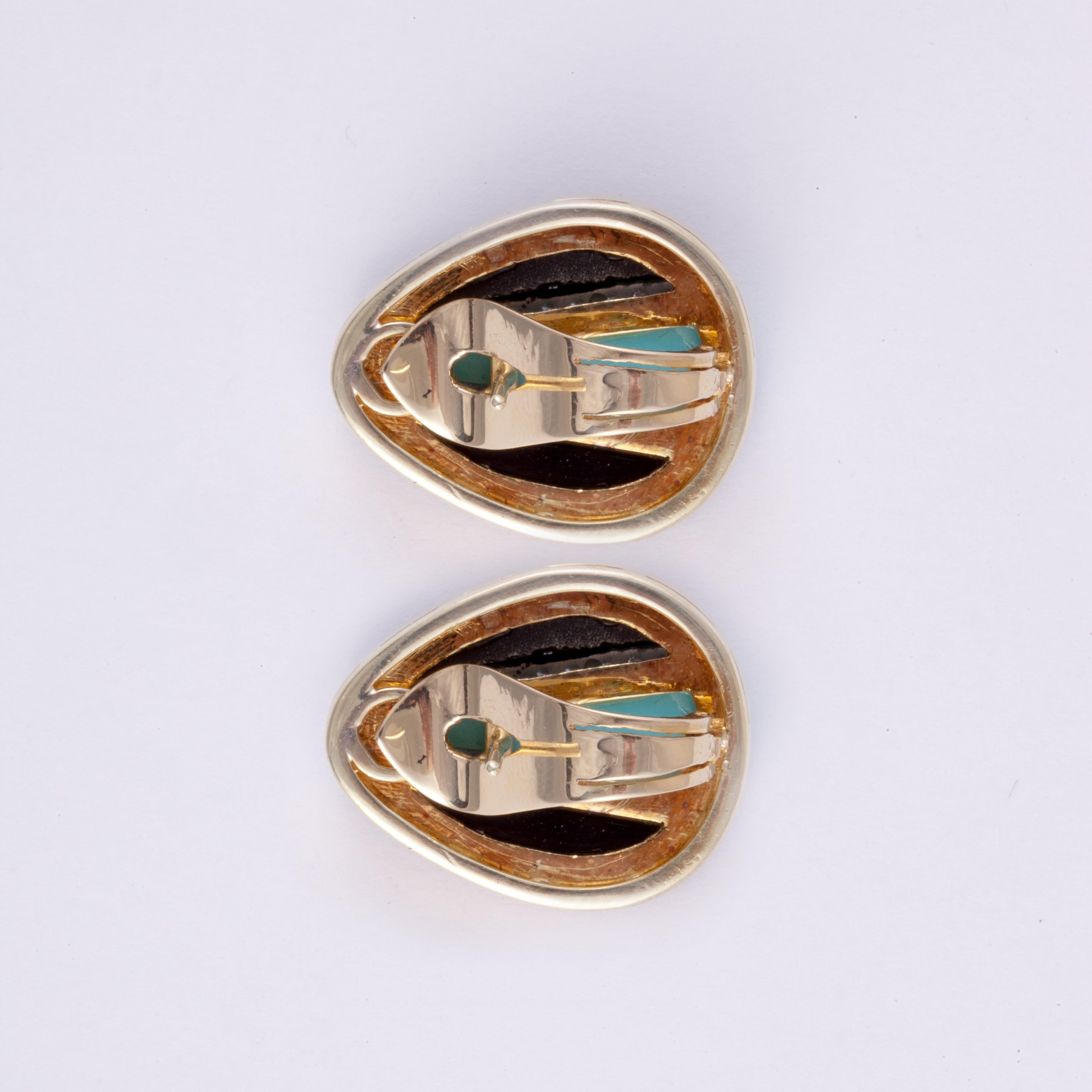 18K two-tone gold earrings featuring onyx and turquoise accented with round diamonds..  There are a total of 48 round brilliant-cut diamonds weighing 1 carat; G-H color and VS1-VS2 clarity.  Measure 1 inch long and 7/8 inches at widest point.  For