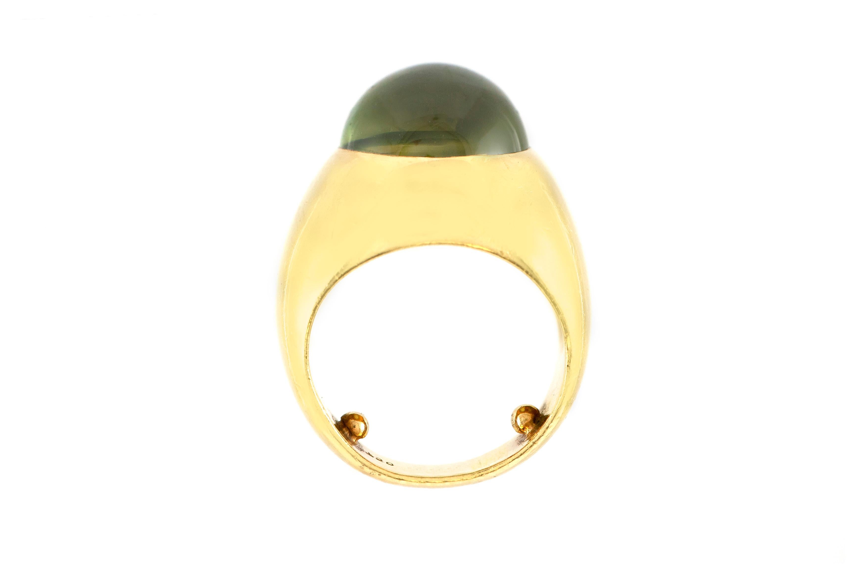 The ring is finely crafted in 18k yellow gold with center stone oval cabochon cat eye ring weighing approximately total of 15.00 carat.