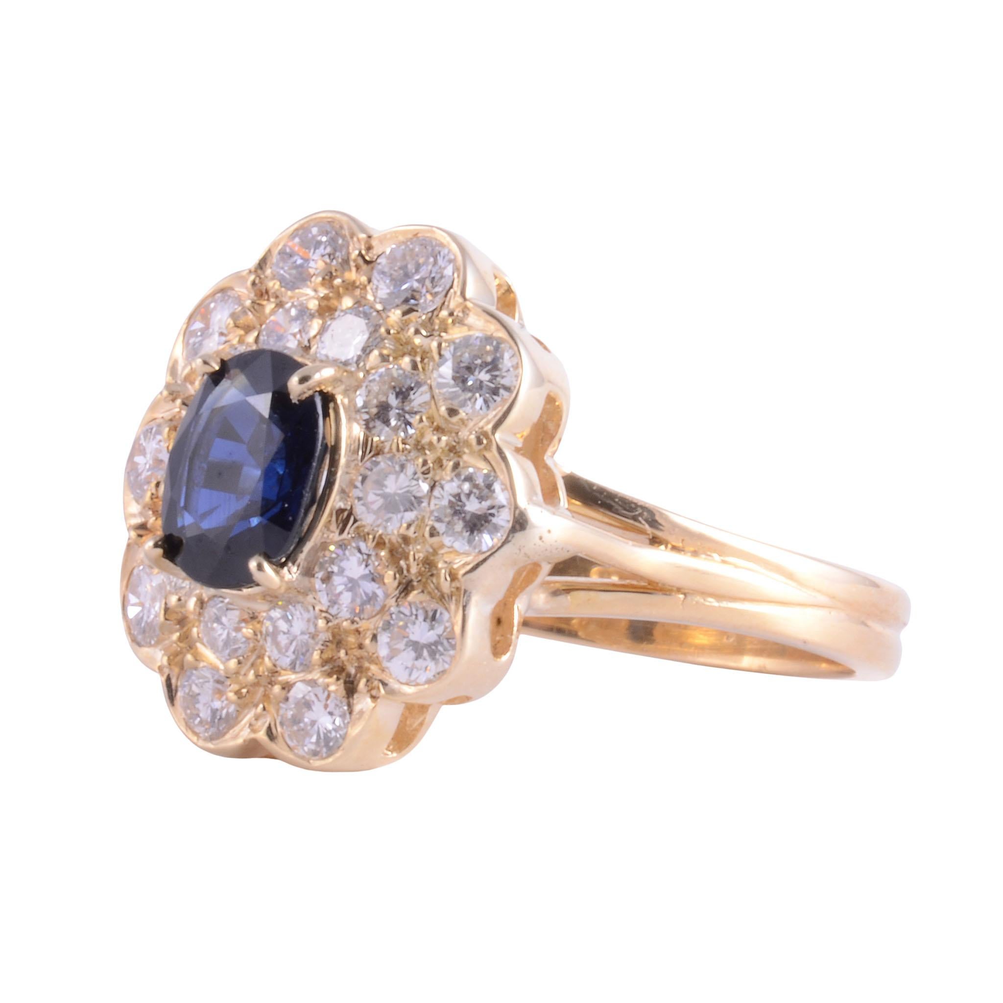 Estate 18K oval sapphire VS Diamond Ring. This 18 karat yellow gold ring features a 0.90 carat oval sapphire and 0.85 carat total weight diamonds with 20 round diamonds VS clarity, G-H color. The sapphire measures 7mm x 5mm and is a fine medium