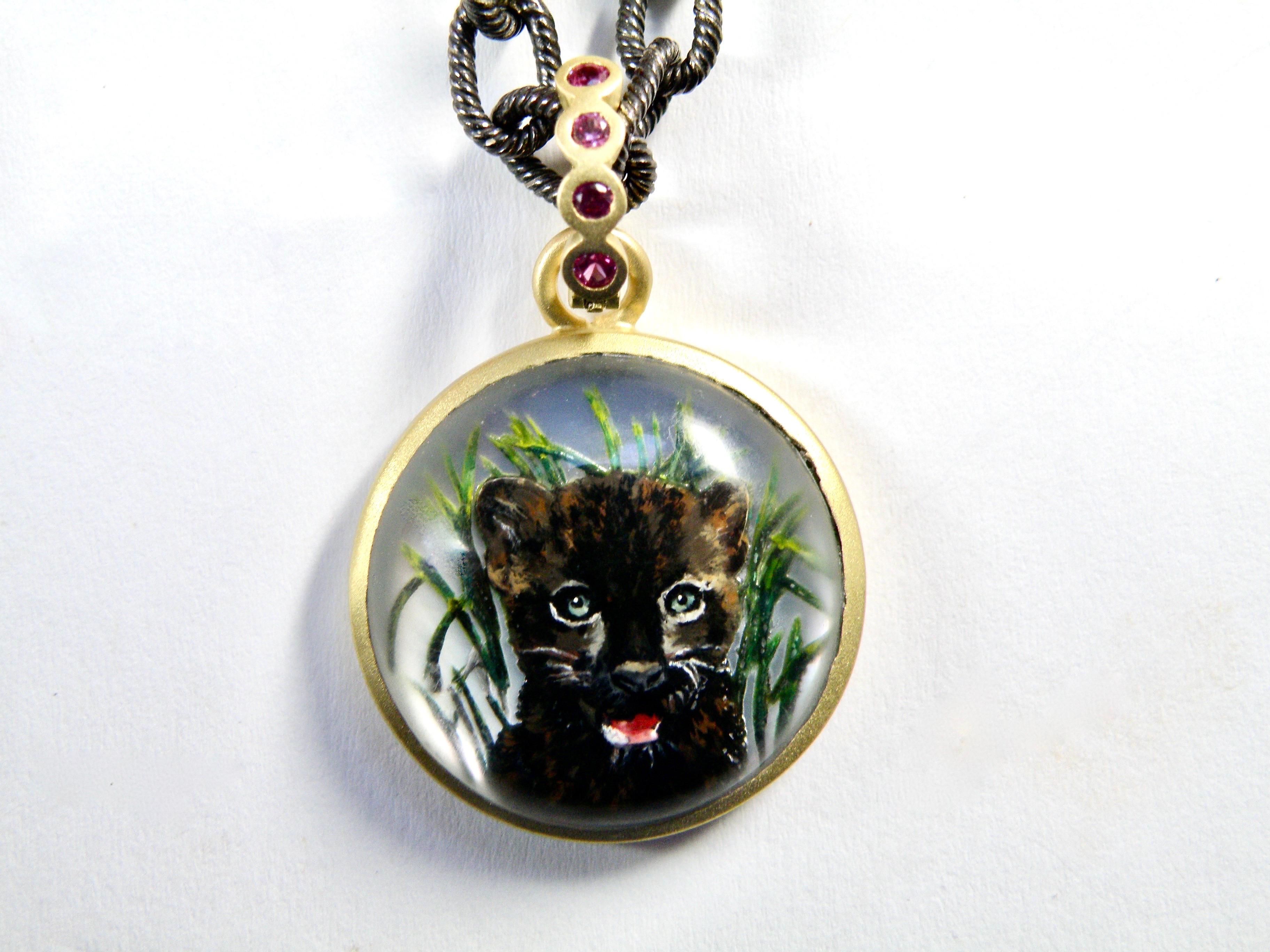 18k hand painted panther cub reverse crystal gem carving in quartz crystal backed with mother -of -pearl carved by master carver from Idar Oberstein 26mm round with .30c arat sapphire bail