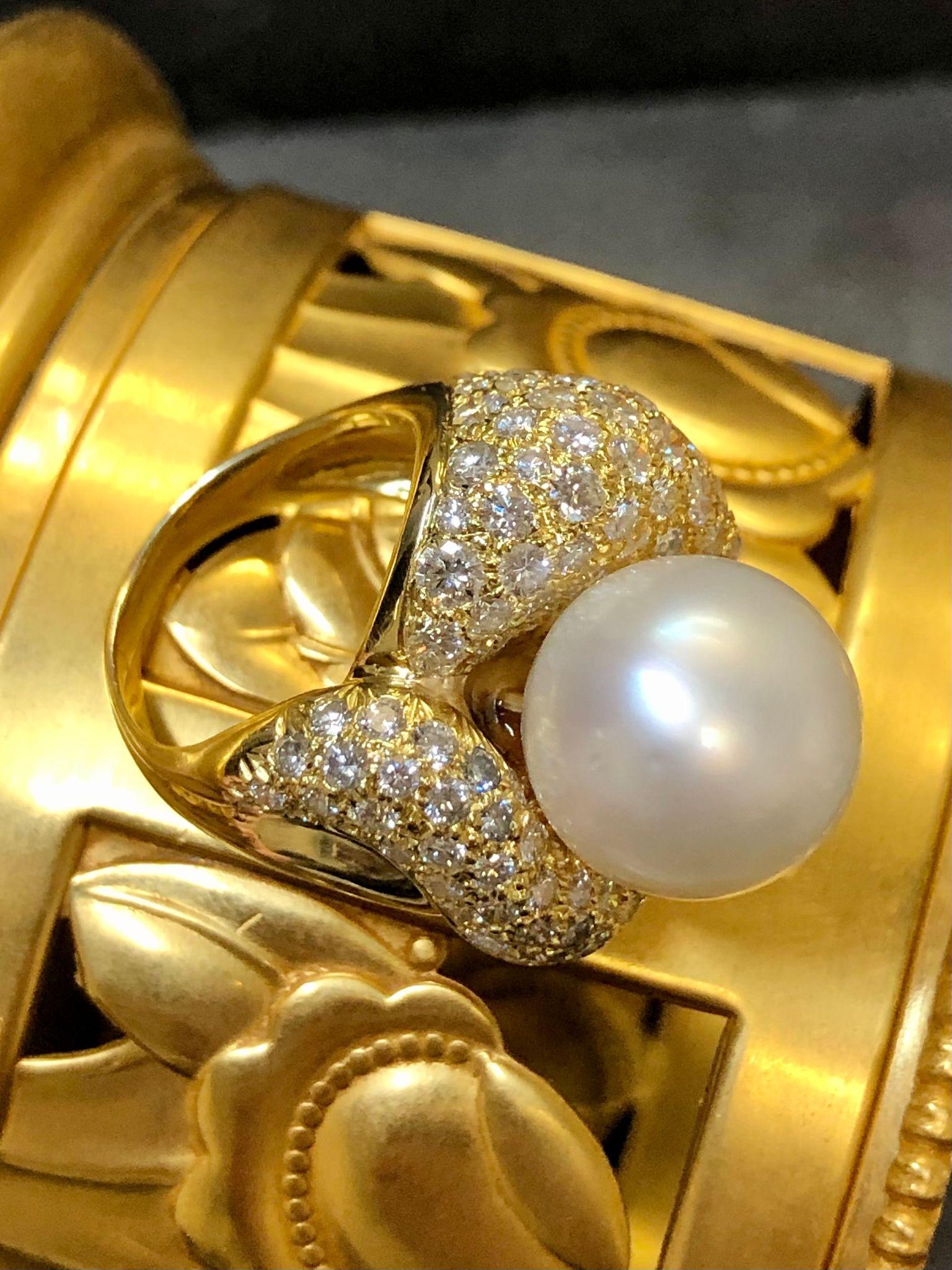 A vintage ring done in 18K yellow gold and set with a approximately 6cttw in F-G color Vs1-2 clarity diamonds and topped with a 13.2mm cream colored South Sea pearl.

Dimensions/Weight
1” wide by .75” top to bottom. Size 5 1/4” (sizable). Weighs