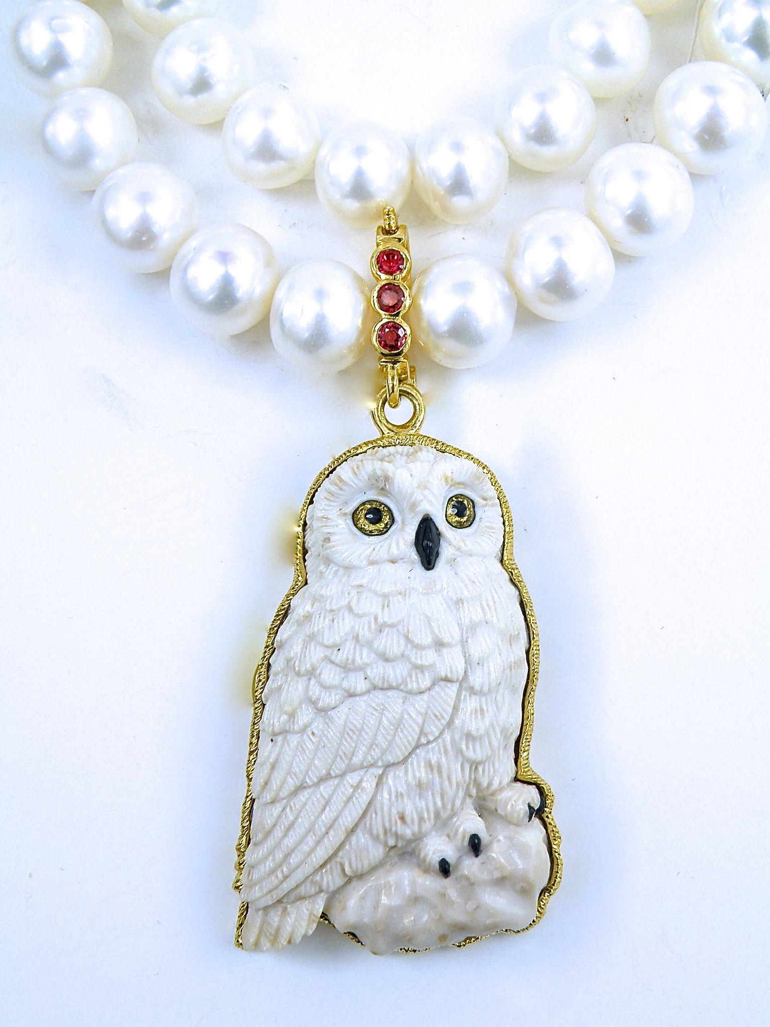 large white opetrified palm owil with citrine eye onyx inlaid beak and claws set in 18K gold 52x333mm and .30 sapphire bail 