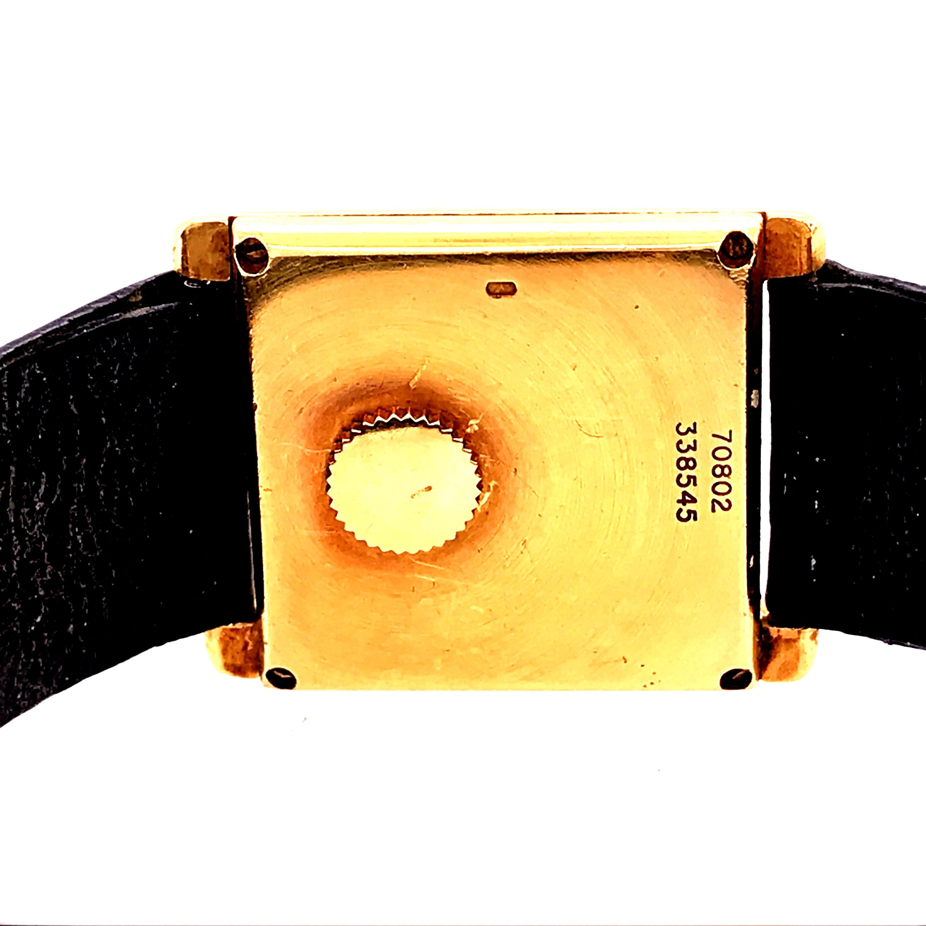 18K Yellow Gold Piaget Tank Watch with black leather band.  Square black Face with 18K Yellow Gold Case & Buckle.  70802  338545