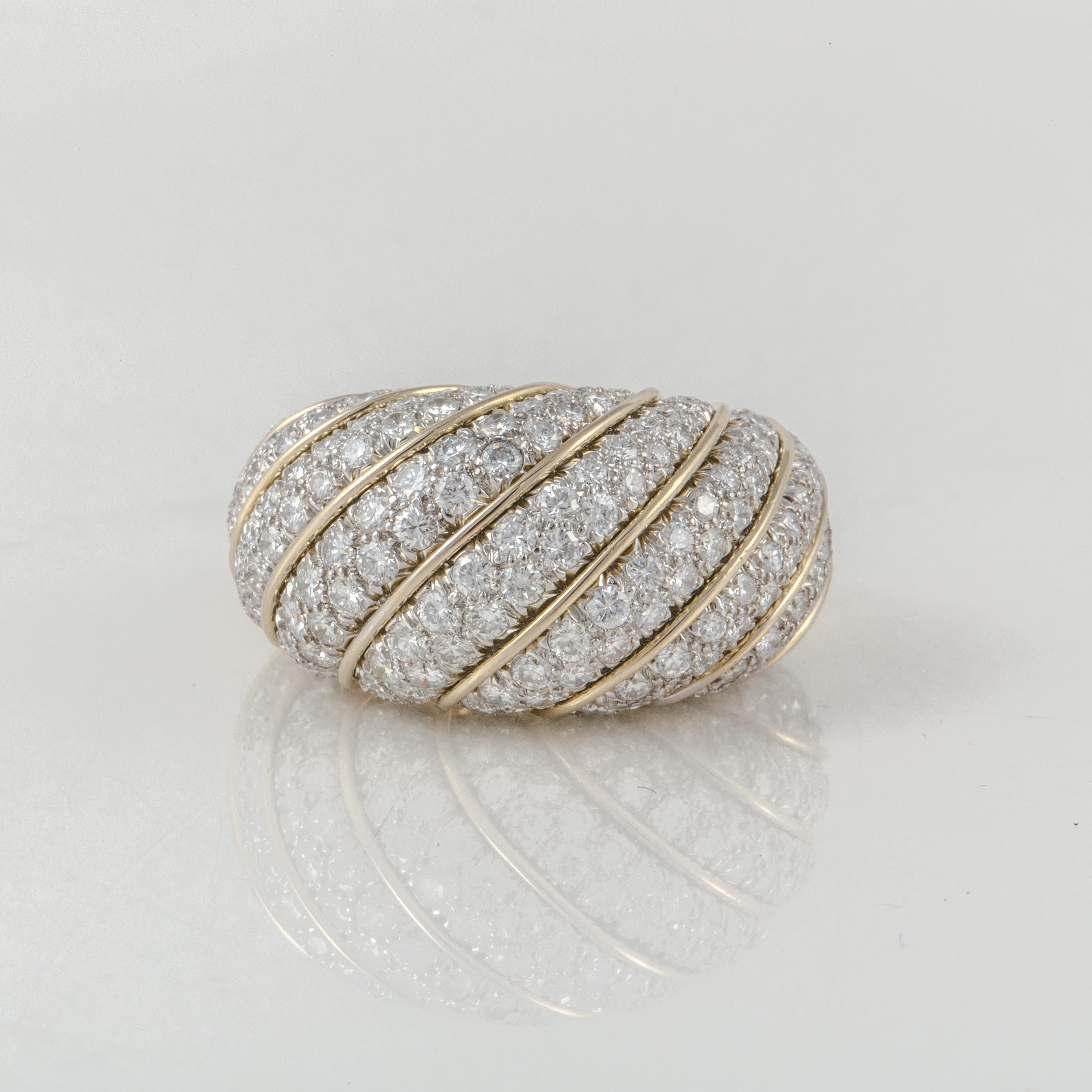 Dome ring composed of 18K yellow gold and platinum with pavé round diamonds.  There is a total of 181 round diamonds that total 5.40 carats; G-H color and VS1-2 clarity.  Measures 1 1/16 inches long, 9/16 inches wide and stands 1/2 inch off the