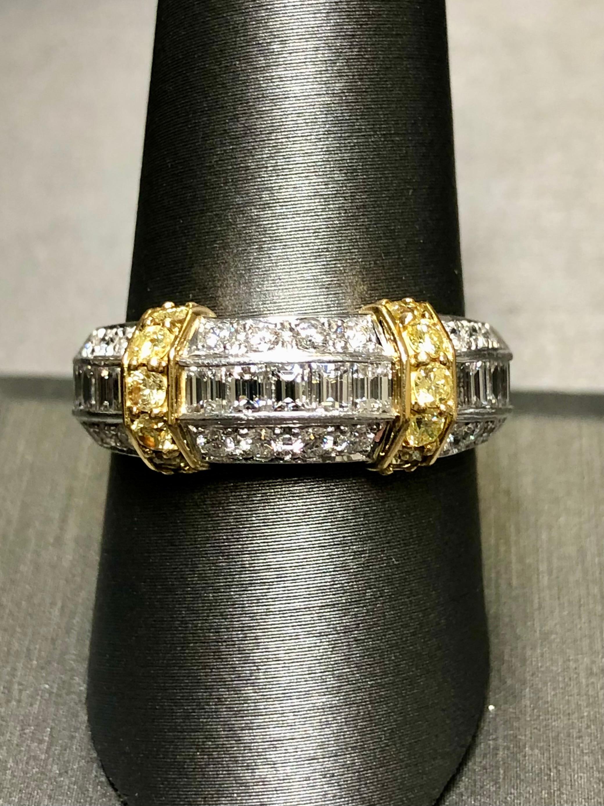 Gorgeous in its simplicity, this ring is done in platinum with 18K yellow gold accents and channel/bead set with approximately 1.51cttw in G-H color Vs1 clarity round and wide baguette diamonds along with fancy yellow (we believe untreated) round