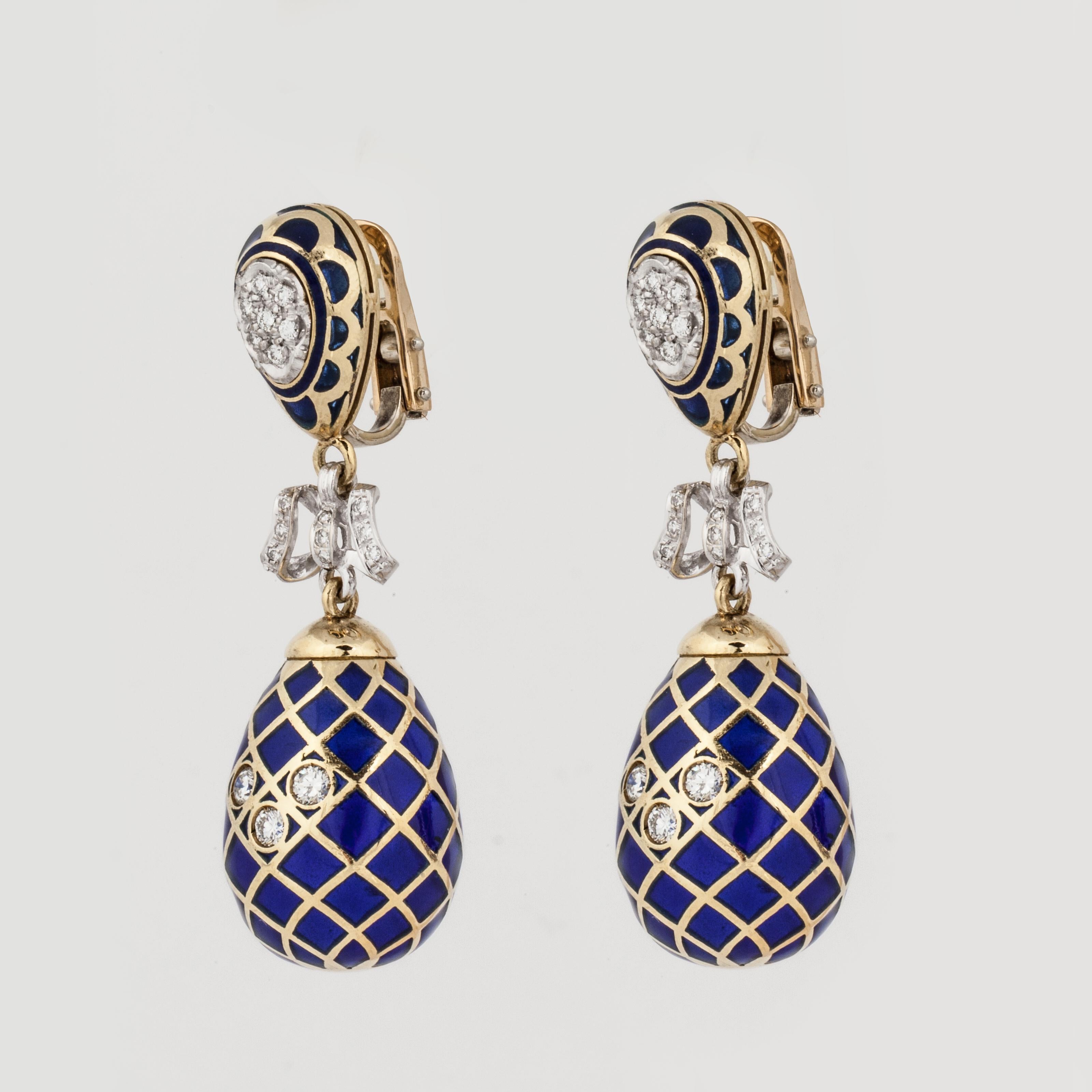 18K yellow and white gold drop earrings composed of plique-à-jour and round diamonds. There are 38 round diamonds in white gold that total 1.40 carats, G-H color and VS clarity.  The large egg-shaped drops are cobalt blue plique-à-jour with round